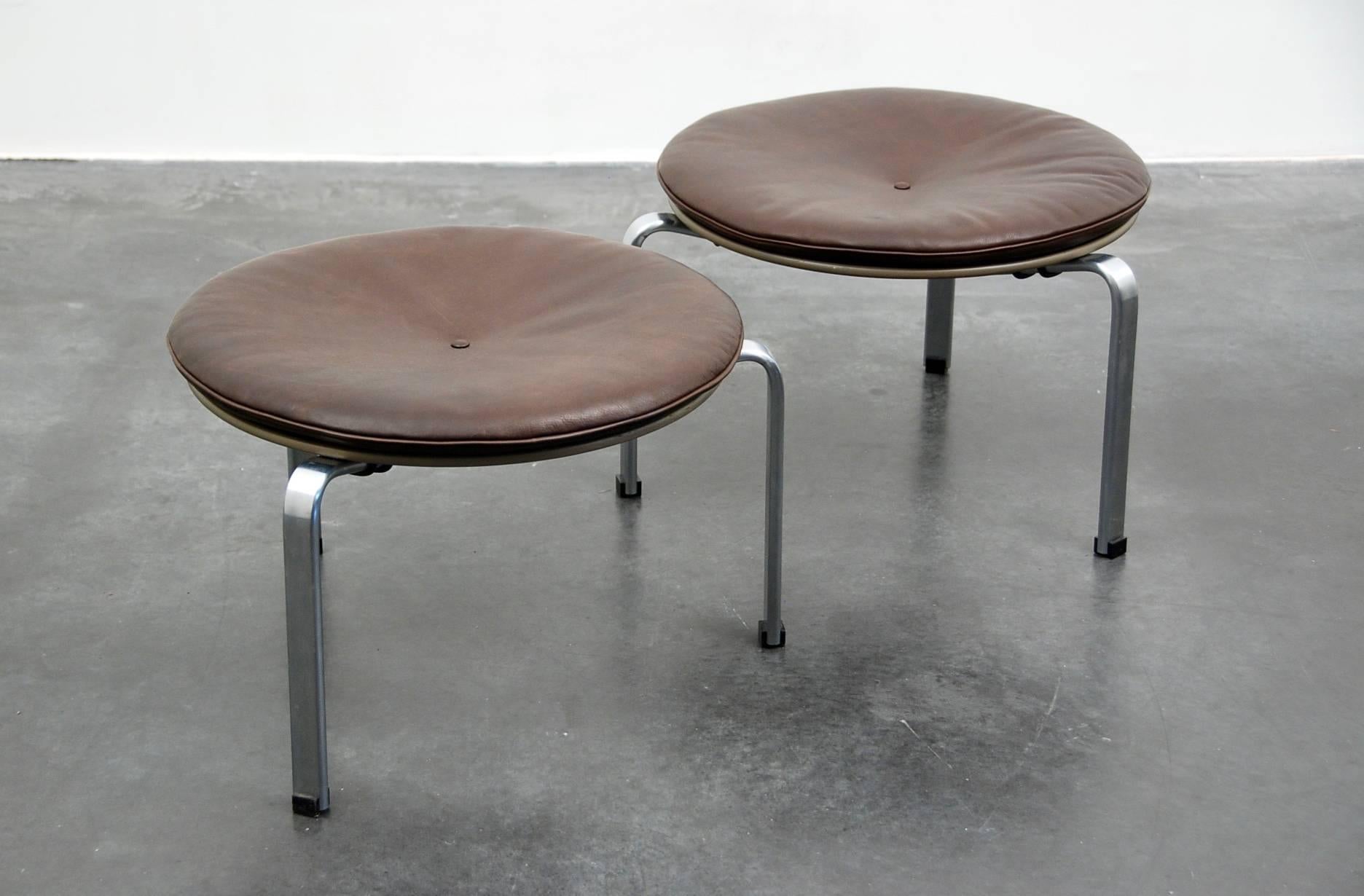 Poul Kjærholm pair of stools for E Kold Kristensen, Denmark, 1958, model PK33 with steel Frame and cushion in brown leather.
  