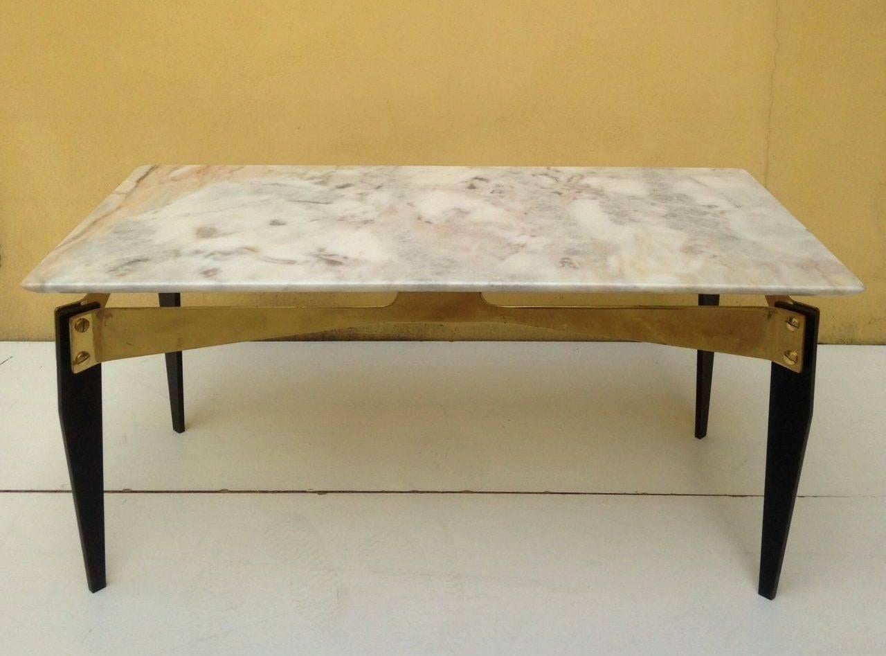 Amazing coffee table in iron, brass and marble attributed to Melchiorre Bega.
 
Thick solid brass plate curved and shaped to hold the marble top which seems to float above the legs.
Original conditions.

We have many more items not published