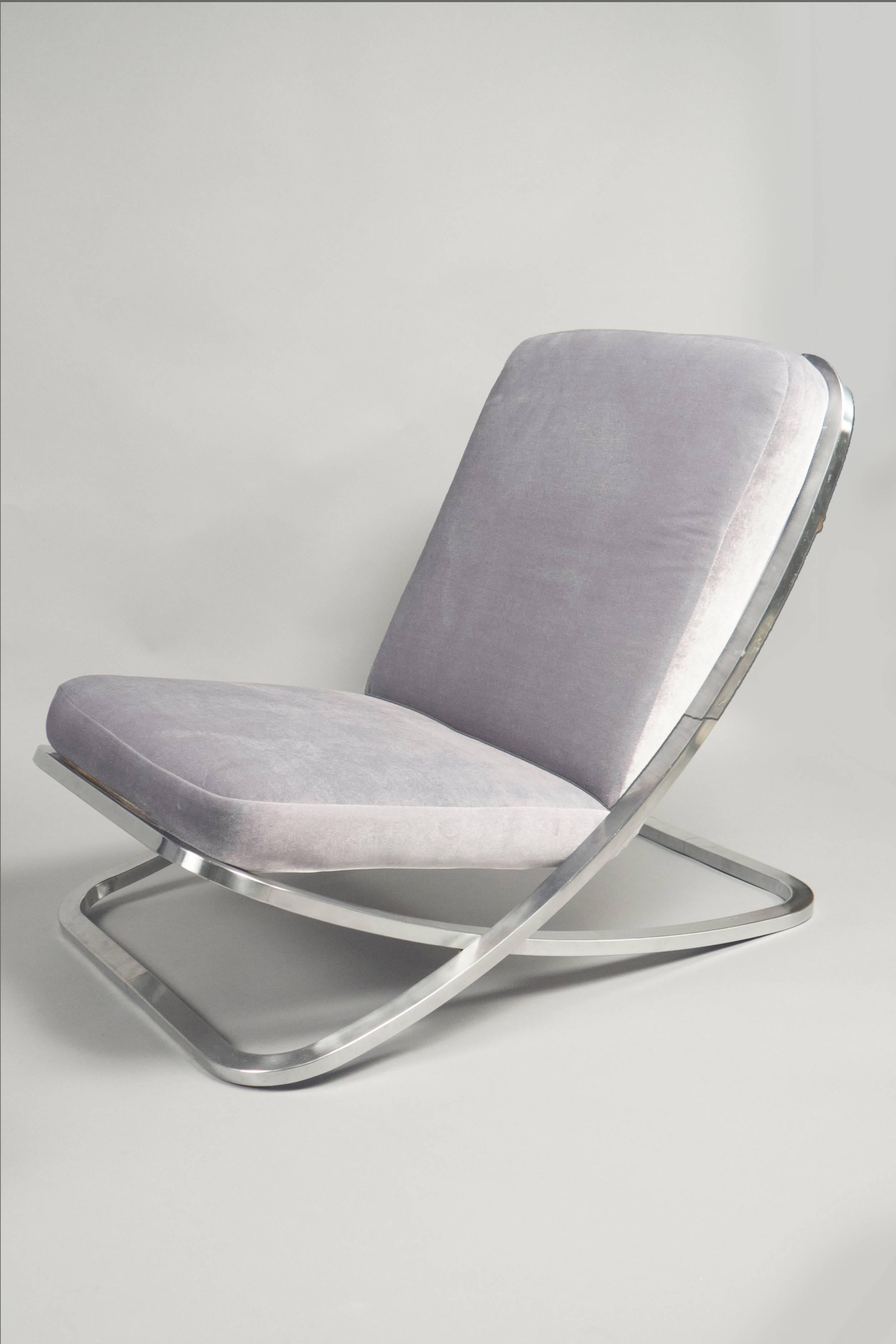 Ultra low lounge chairs composed of crisscrossed nickel frames with attached over-upholstered velvet cushions. 





 