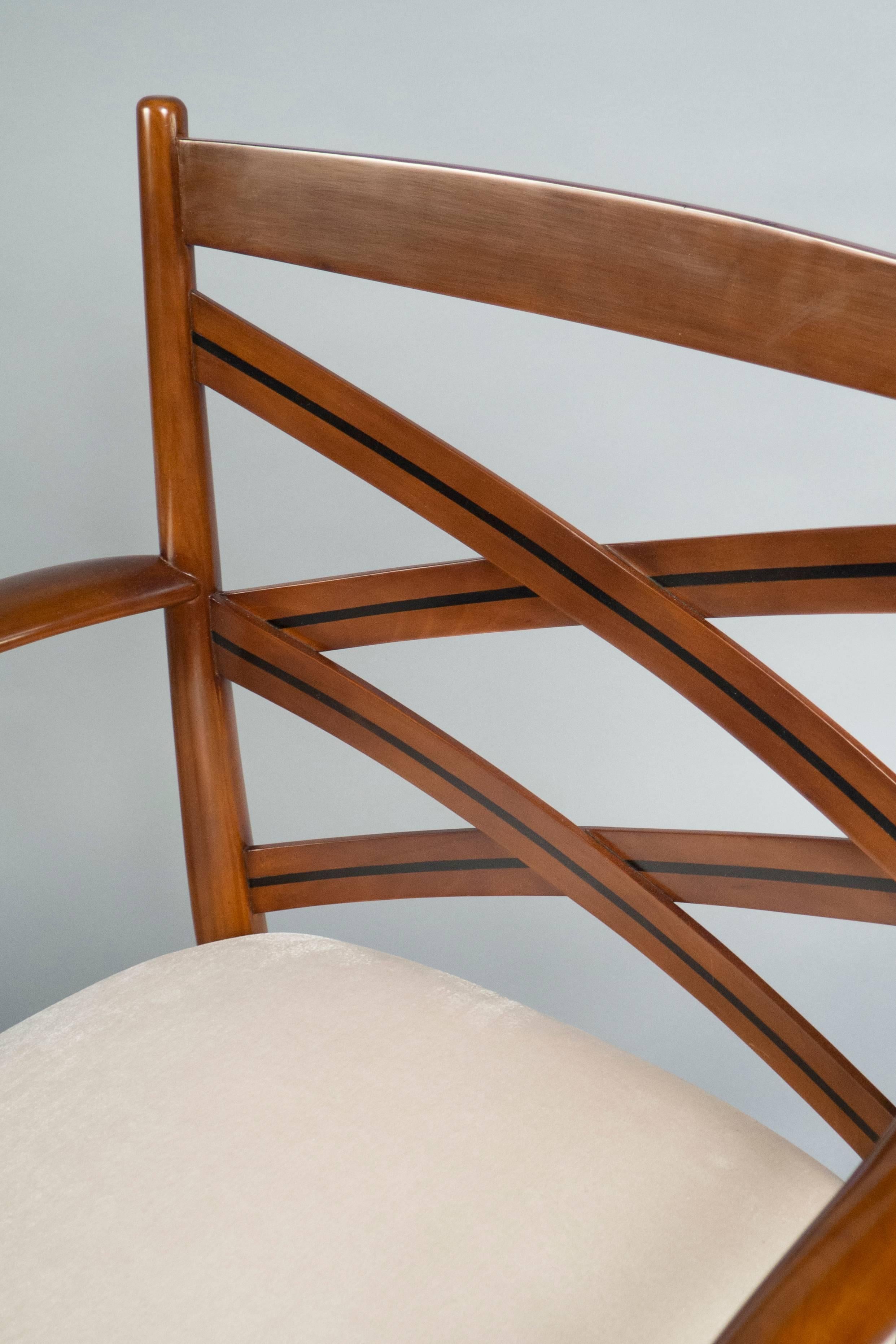 Tinted pearwood, inlaid with ebony in the criss-crossing back sections with curved arm supports. Stretchers between front and back legs were added for stability.


Measures: Height back 31”, width 25”, depth 25”
seat height 16”.
 