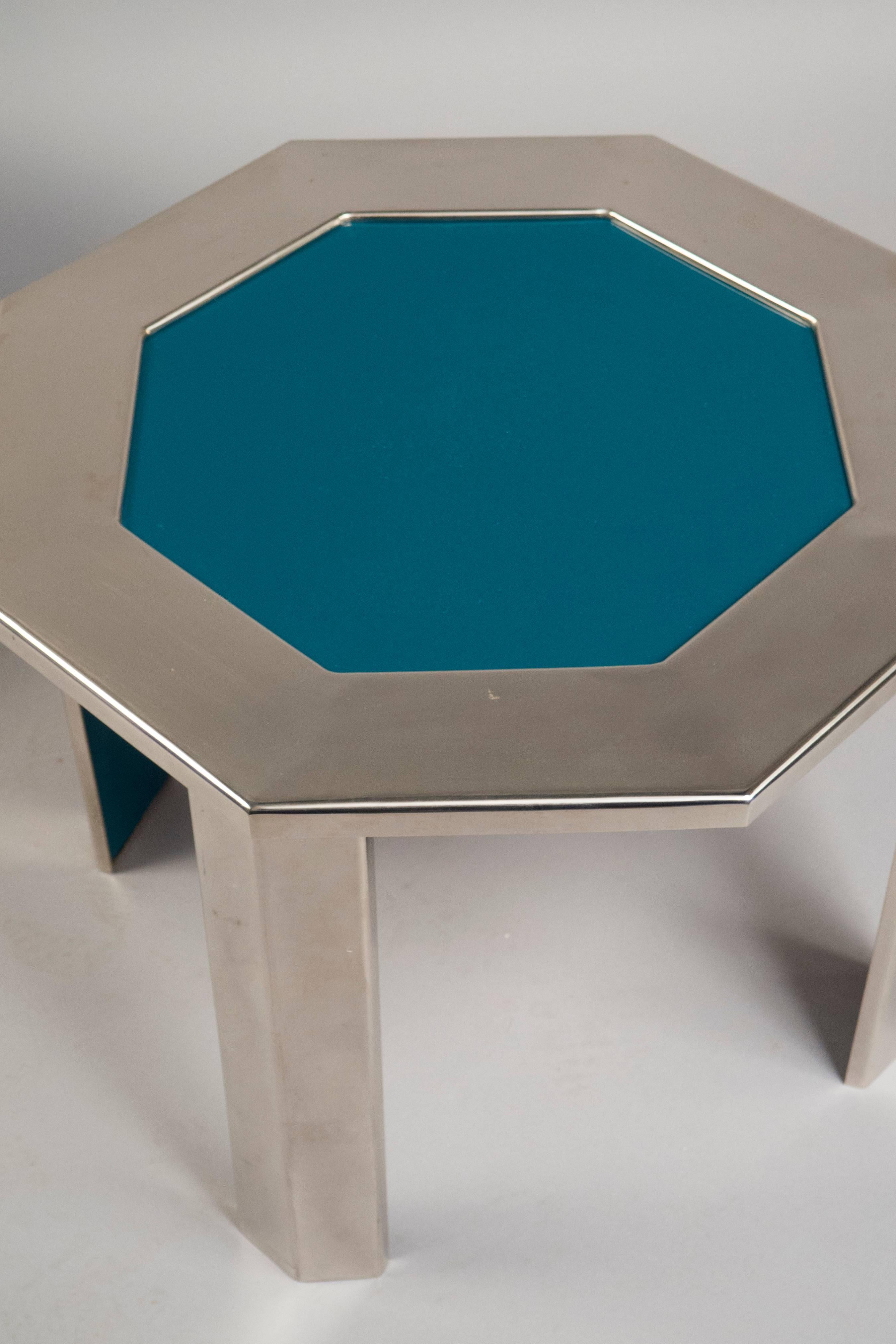 Octagonal nickeled steel frame tables, each top featuring a turquoise formica inlay. The insides of the legs are also covered in formica.