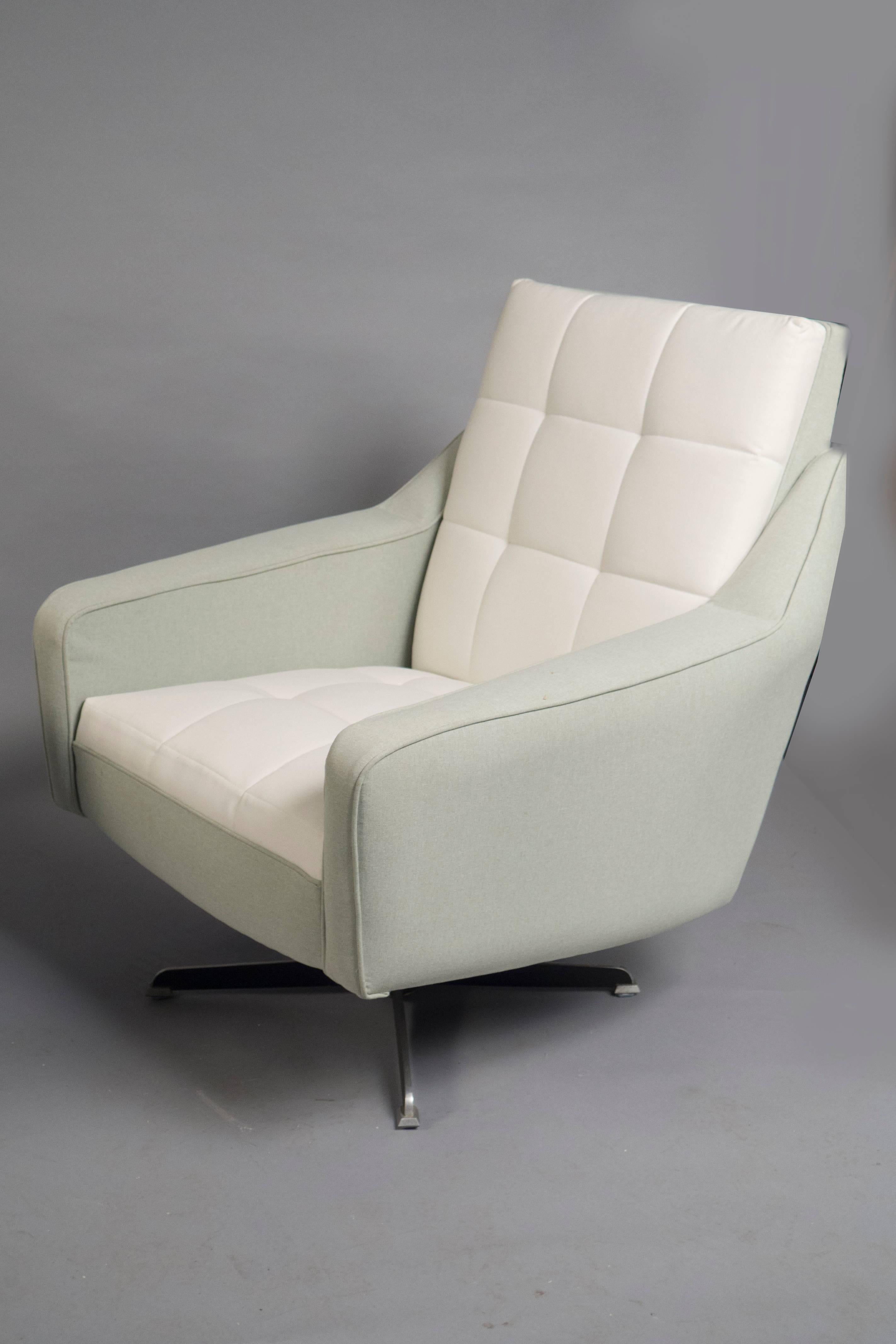 Over-upholstered pair of bergères, each featuring light pistachio colored backs and sides, the seat and back upholstered in white fabric.
