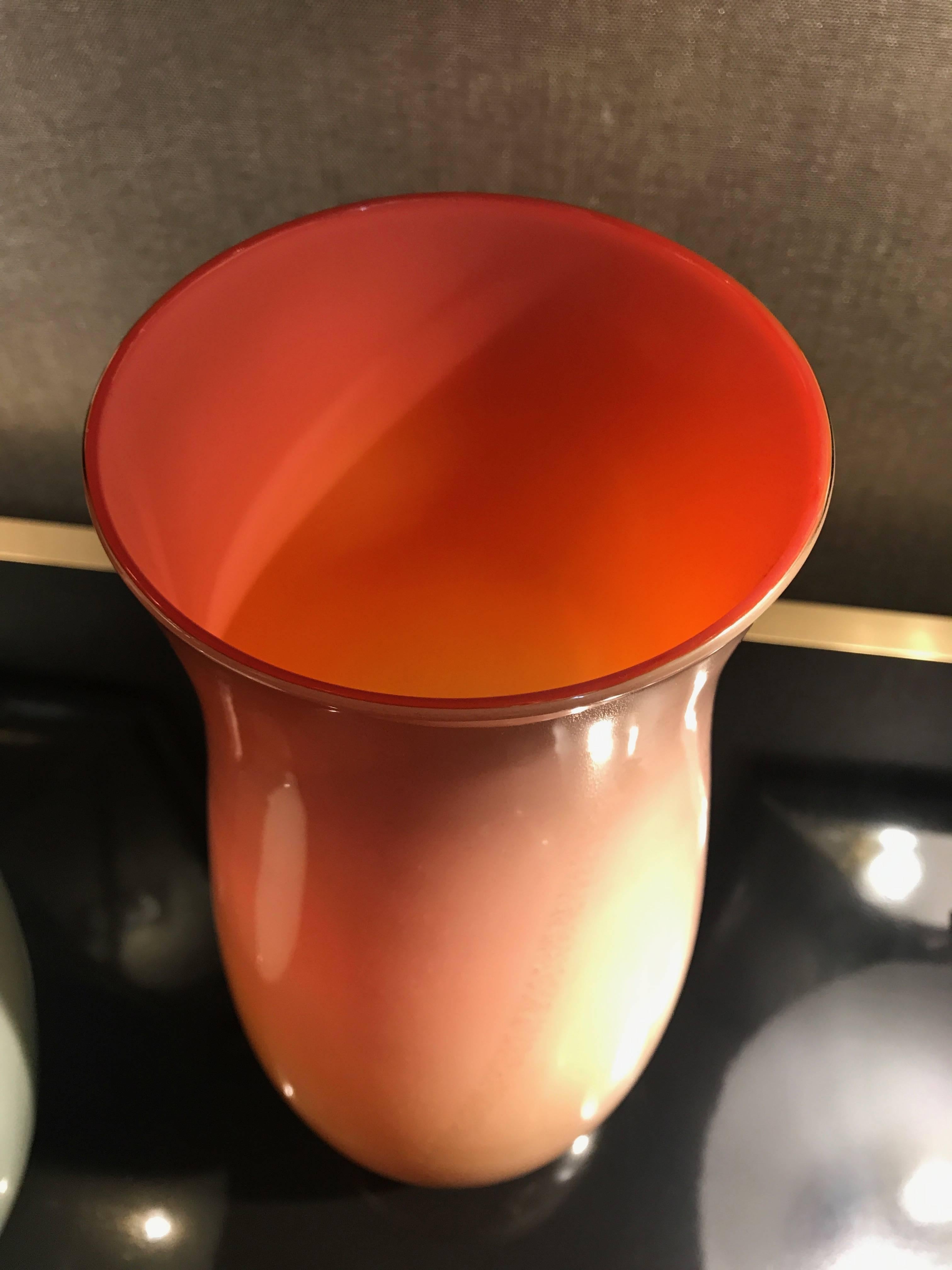 Rose-colored baluster-shaped glass vase with gold fleck inclusions throughout, raised on a clear and gold glass base. Similar model pictured in Marc Heiremans’ Murano Glass” page 43 and Venini’s “Catalogue Raisonne” on page 120. Model LAGUNA.
 