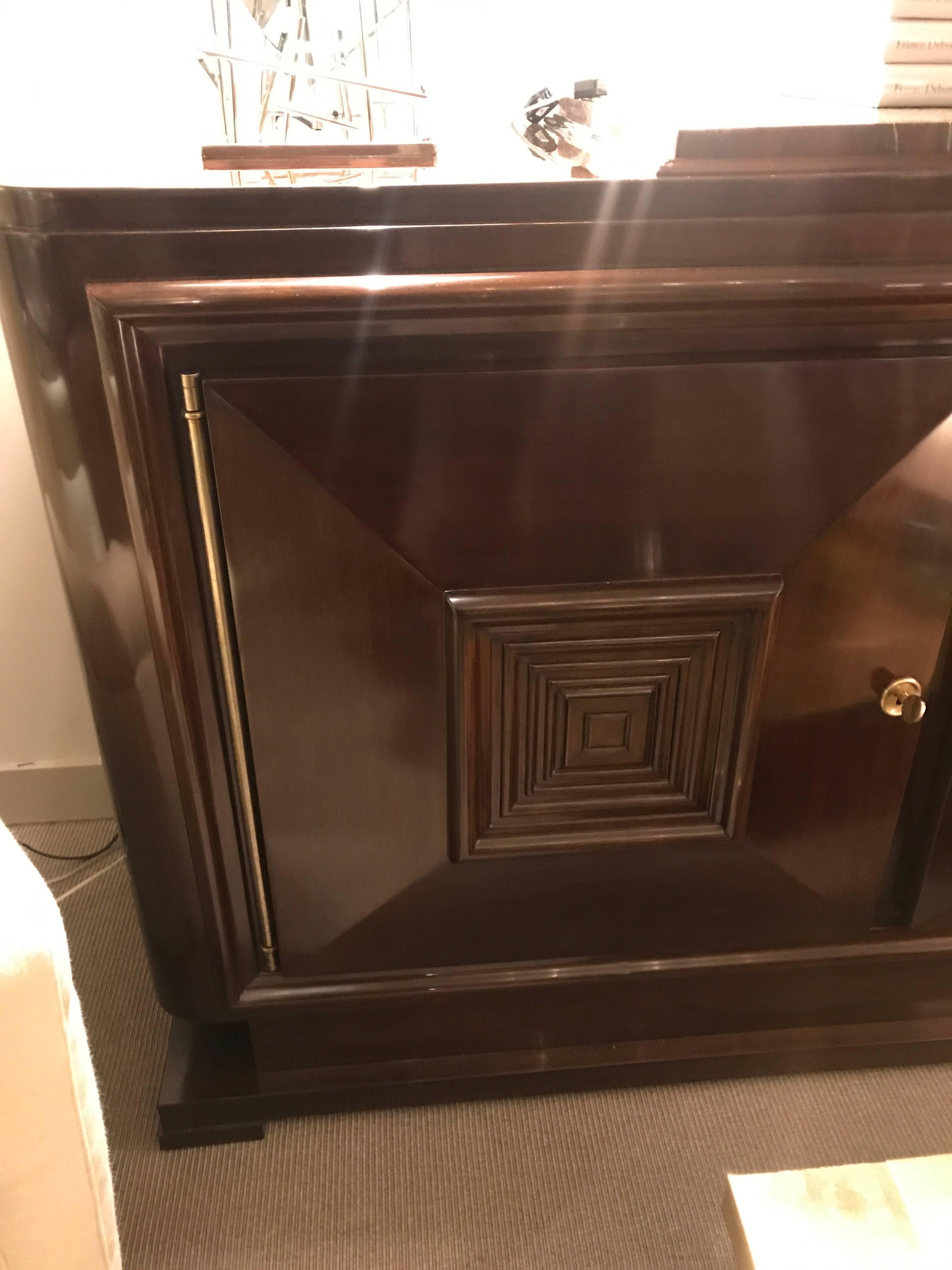 Mahogany, bronze trim, and original “campan rubané” marble, comprising three locking doors faced with nested square molding and enclosing adjustable shelves; on a raised plinth with block feet.
