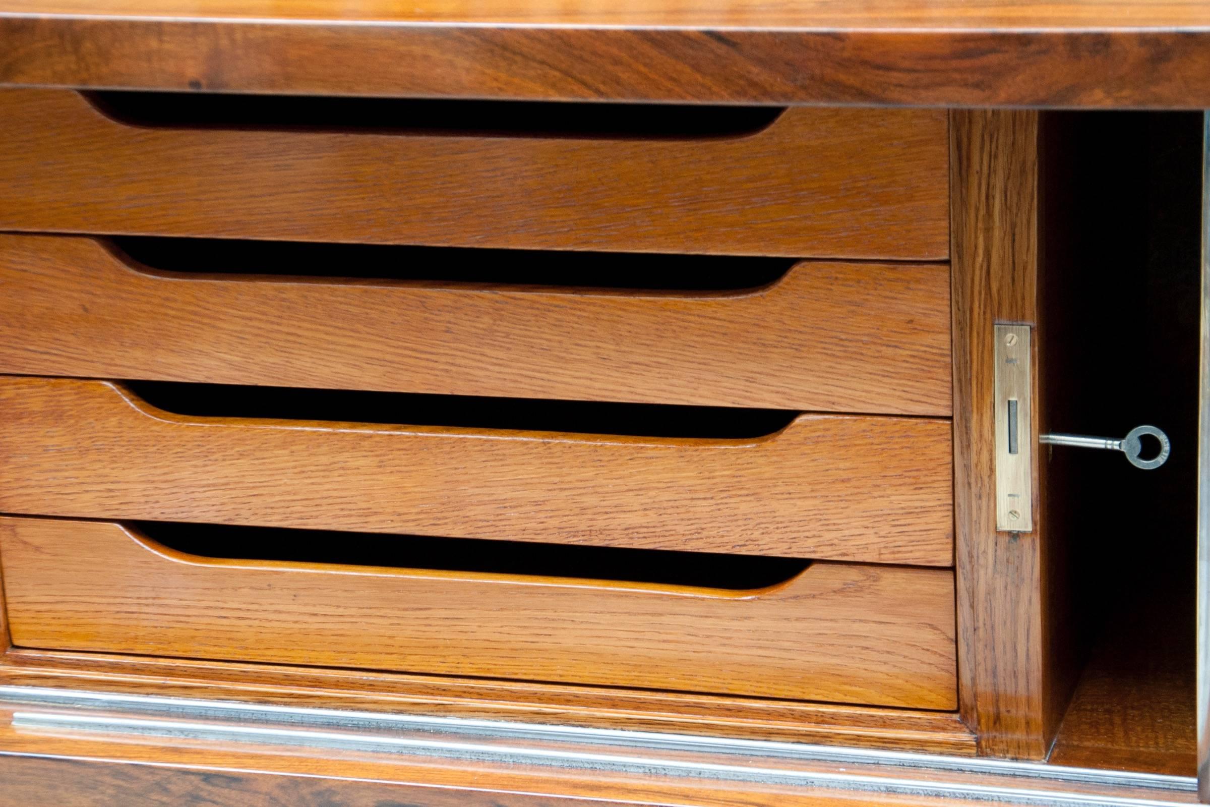 Walnut sideboard with nickeled metal details, stepped slabs of original Sienna marble top, two rows of four sliding doors, interior with four drawers and shelves. Certificate of Authenticity available. The carcass and interior of the cabinet are