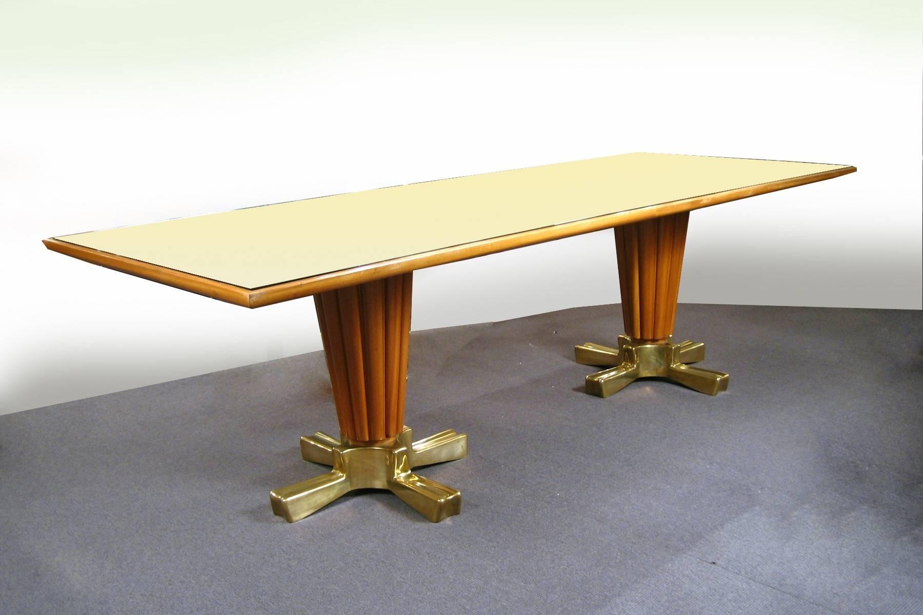 Italian walnut with bronze feet and parchment inset with glass, composed of two tapering, fluted columns, each on four shapely feet, supporting a parchment lined surface, protected with glass.

OUR REFERENCE N4128