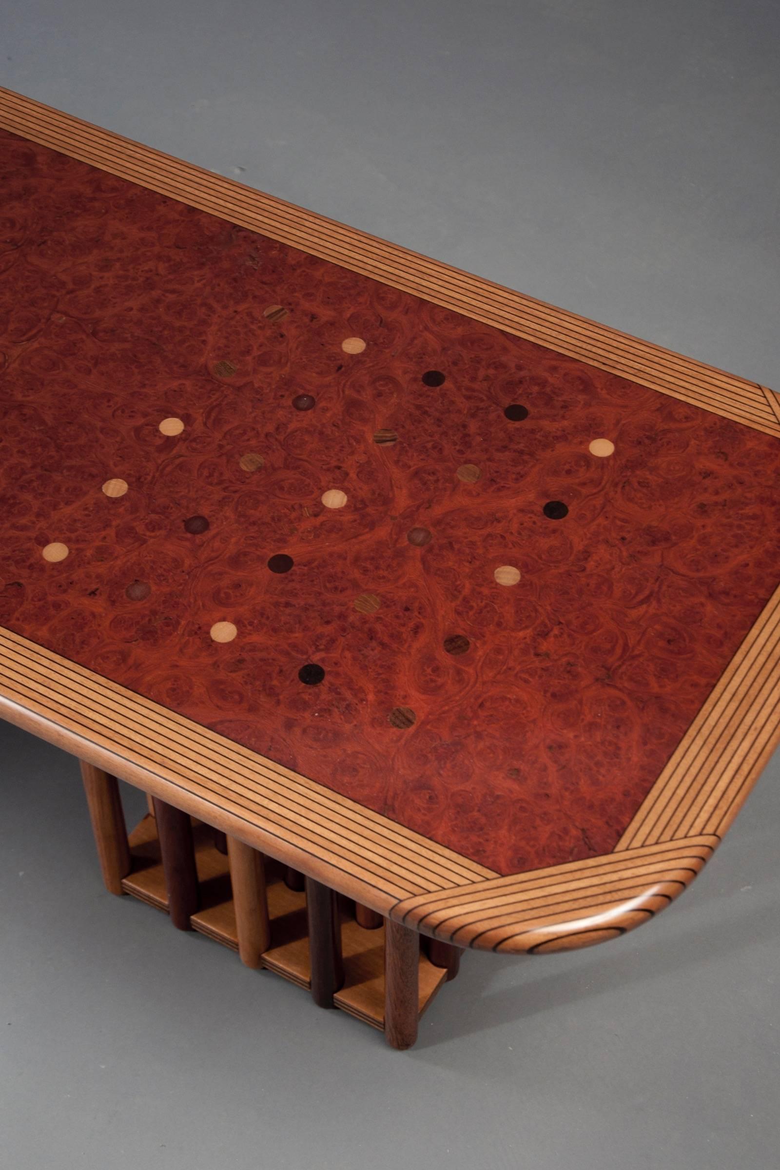 Walnut, burl walnut, rosewood and ebony rectangular table with a striated edge; raised on two supports composed of numerous dowels of exotic wood, from the Scarpas’ “Artona” series.

OUR REFERENCE N8108