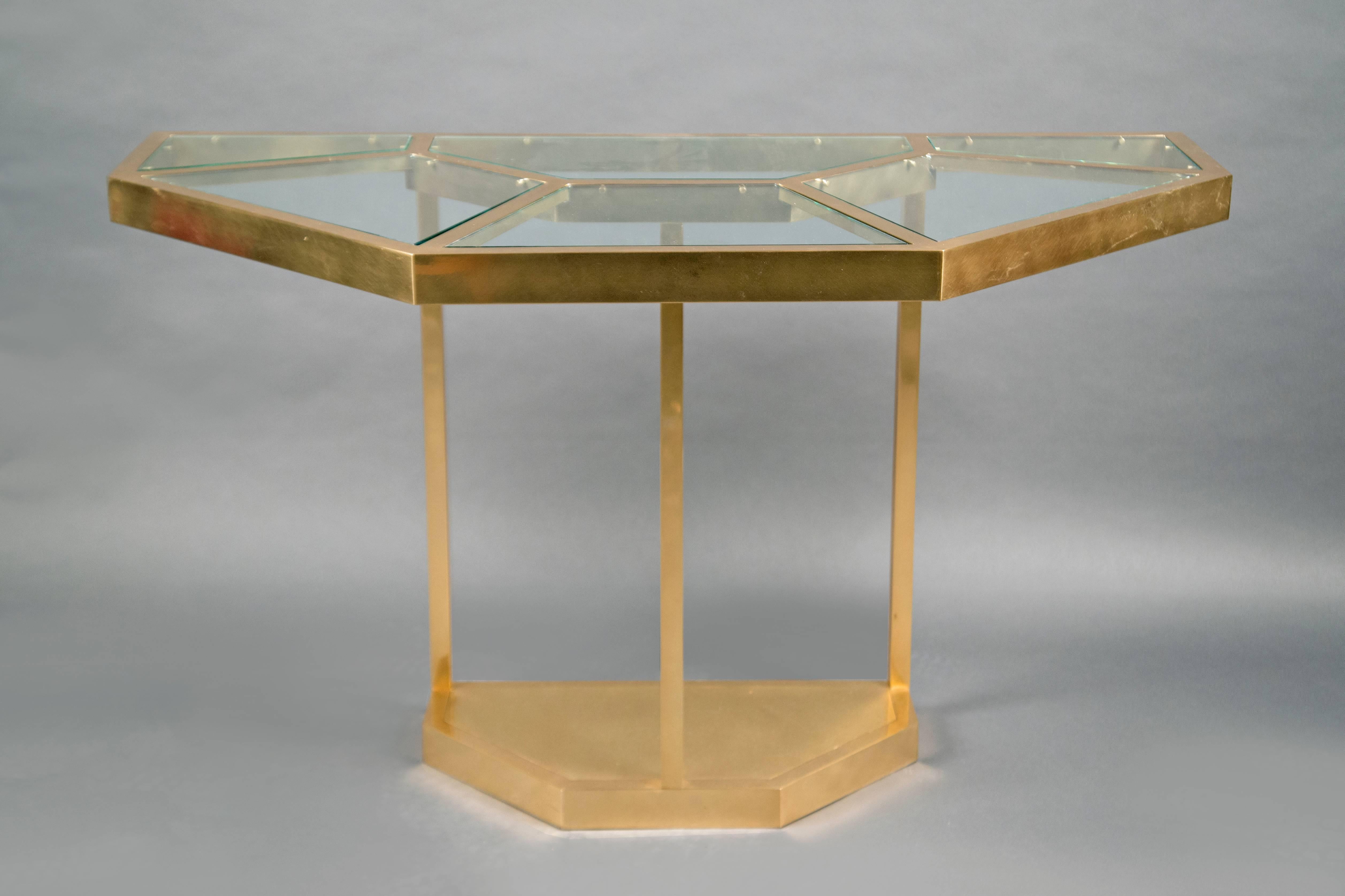 Hexagonal brass structure, the top inlaid with clear glass pieces. The table can be separated in two halves and be used as consoles. Model “Puzzle” from the Series Plurimi. 