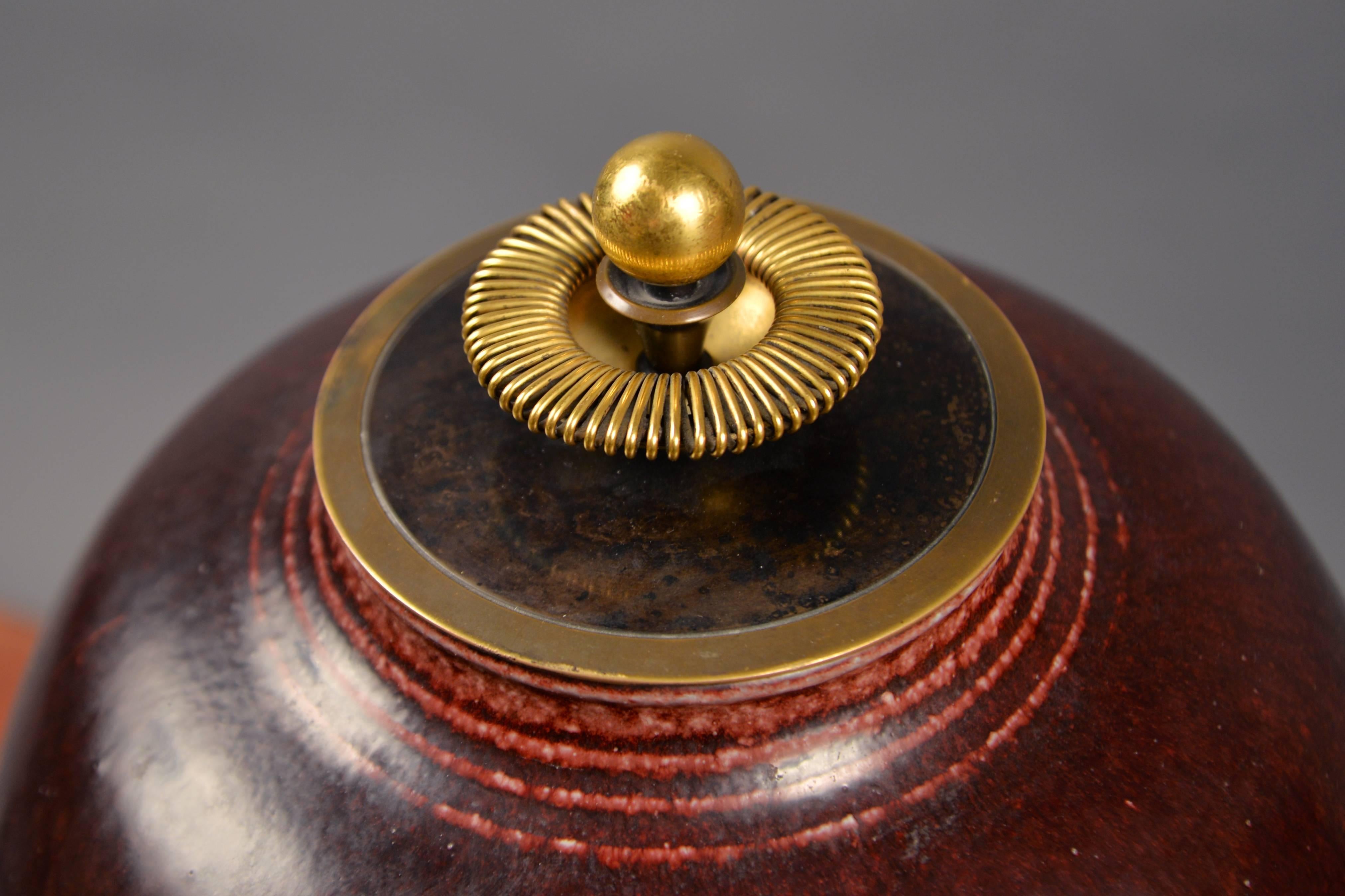 Bulbous stoneware vessel of exceptional scale, decorated in a deep red oxblood glaze; set with a gilt bronze lid by Knud Andersen. Signed and dated on the underside with Bloch’s monogram.


 