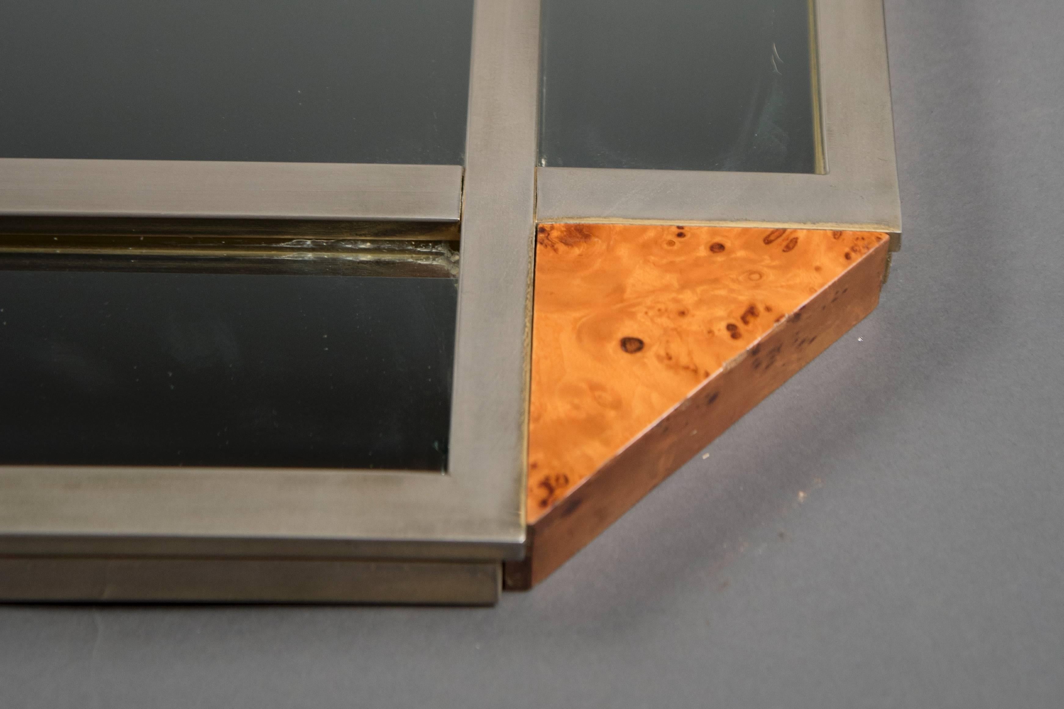 Rectangular steel mirror with canted corners inset with blonde root wood.
  