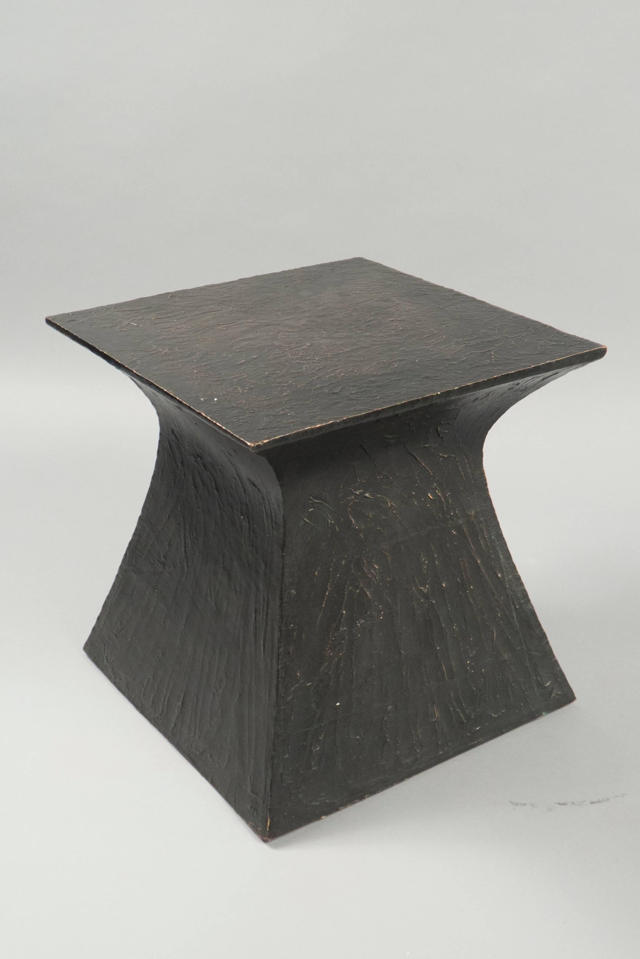 Single side table composed entirely of patinated bronze. This table can also function as a stool as it is very sturdy. Could be accompanied by a custom cushion upholstered with select Spinneybeck leathers.



  