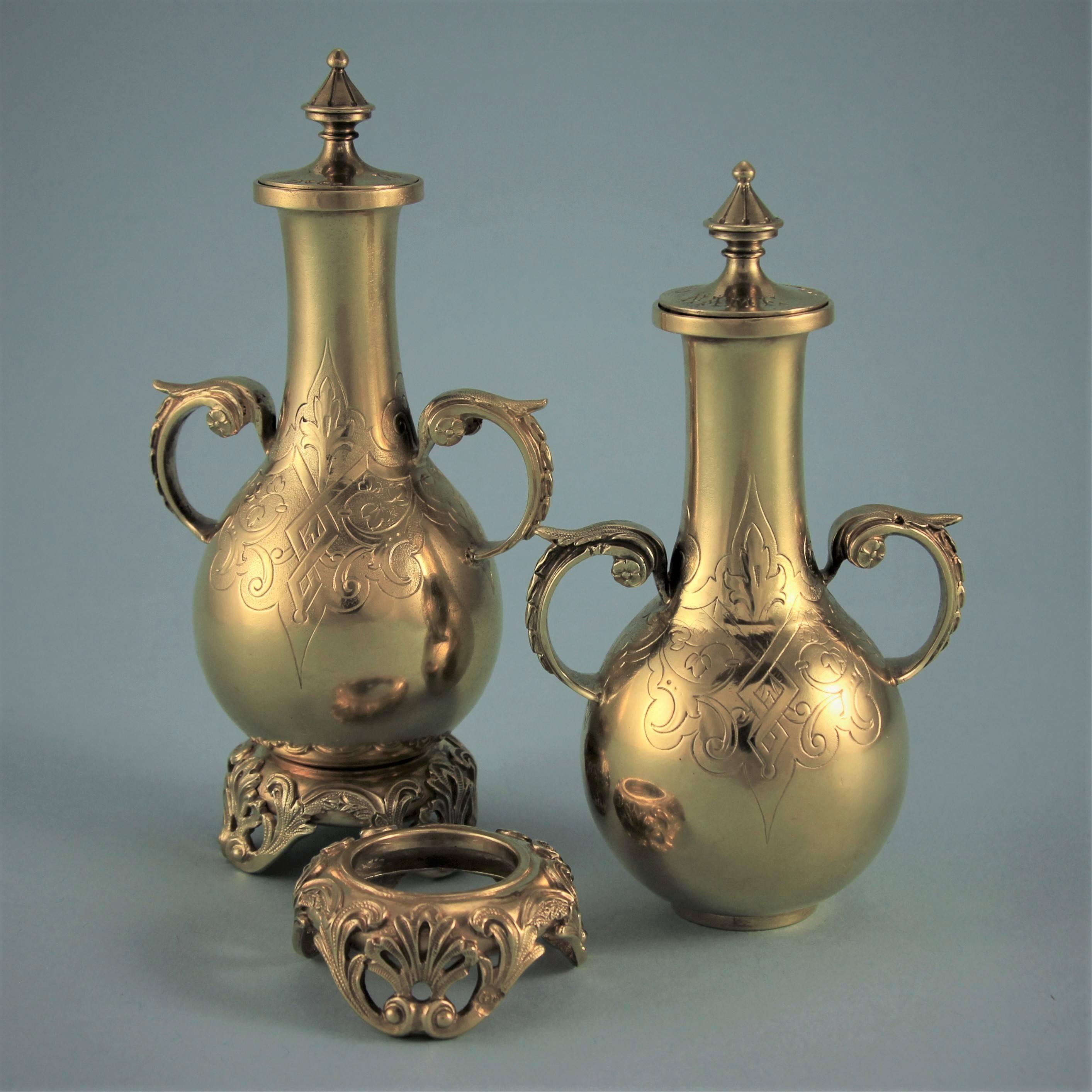 Unusual pair of Victorian silver gilt perfume bottles on stands with an Oriental flavour. 
Maker: George Fox. London, 1871. 

These bottles are extremely well made as one would expect from this maker. The cork on the pull off lids is tipped with