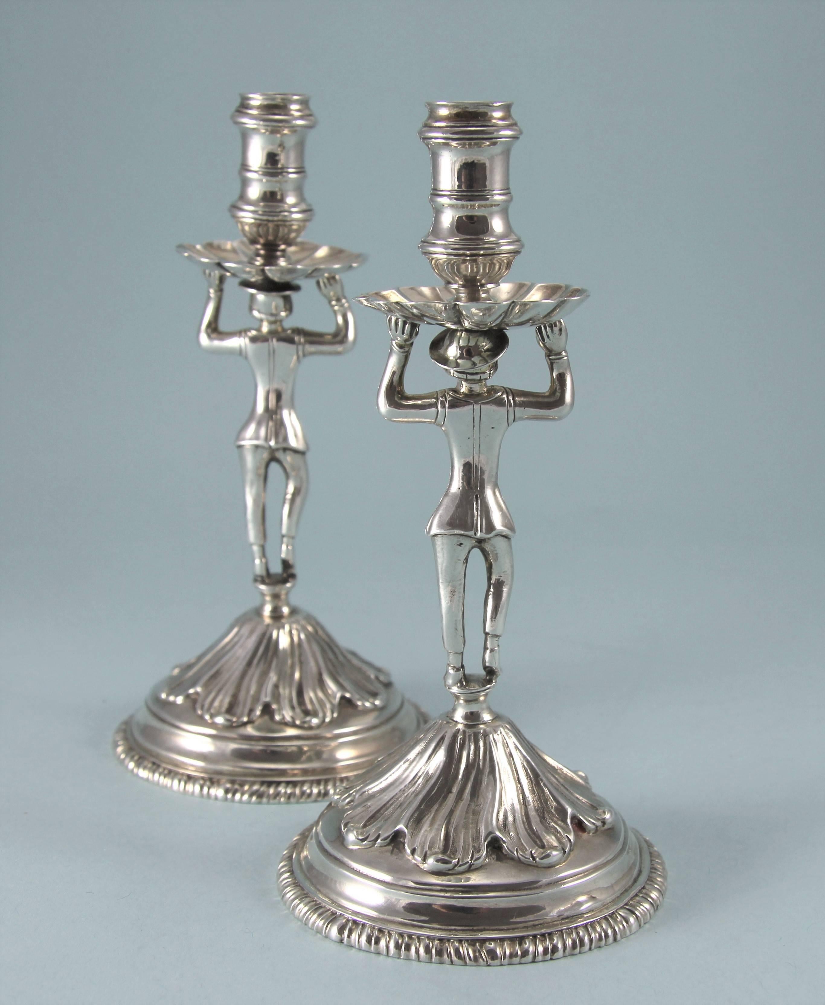 George II rare sterling silver sailor tapersticks. 
Maker: Peter Werritzer. London, 1756. 

Each taperstick has a figure of a Sailor ('Jack Tar'} with raised arms, balancing the socket and drip pan on his head, standing on a small 'capstan'