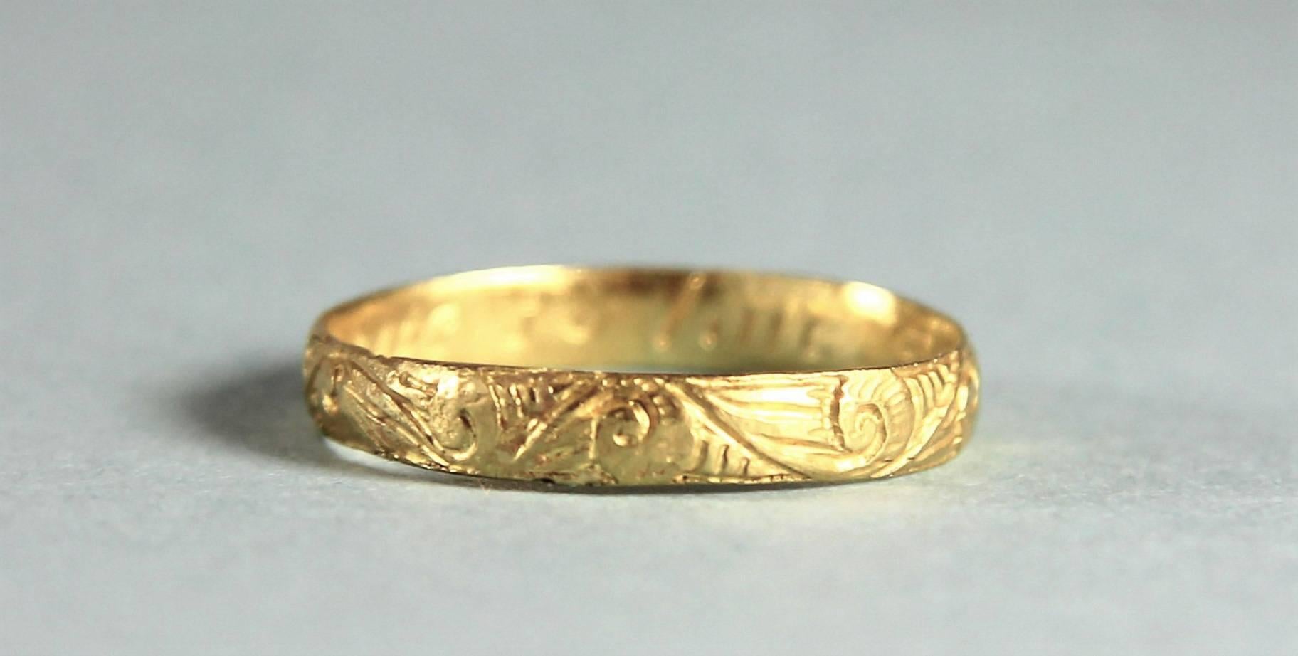 Delicate and very attractive 17th century chased posy ring of high grade gold.
Maker's mark: R. circa 1650

The outside of the ring is chased with foliate scrolls. The inside of the ring is engraved in contemporary script 'Live to love