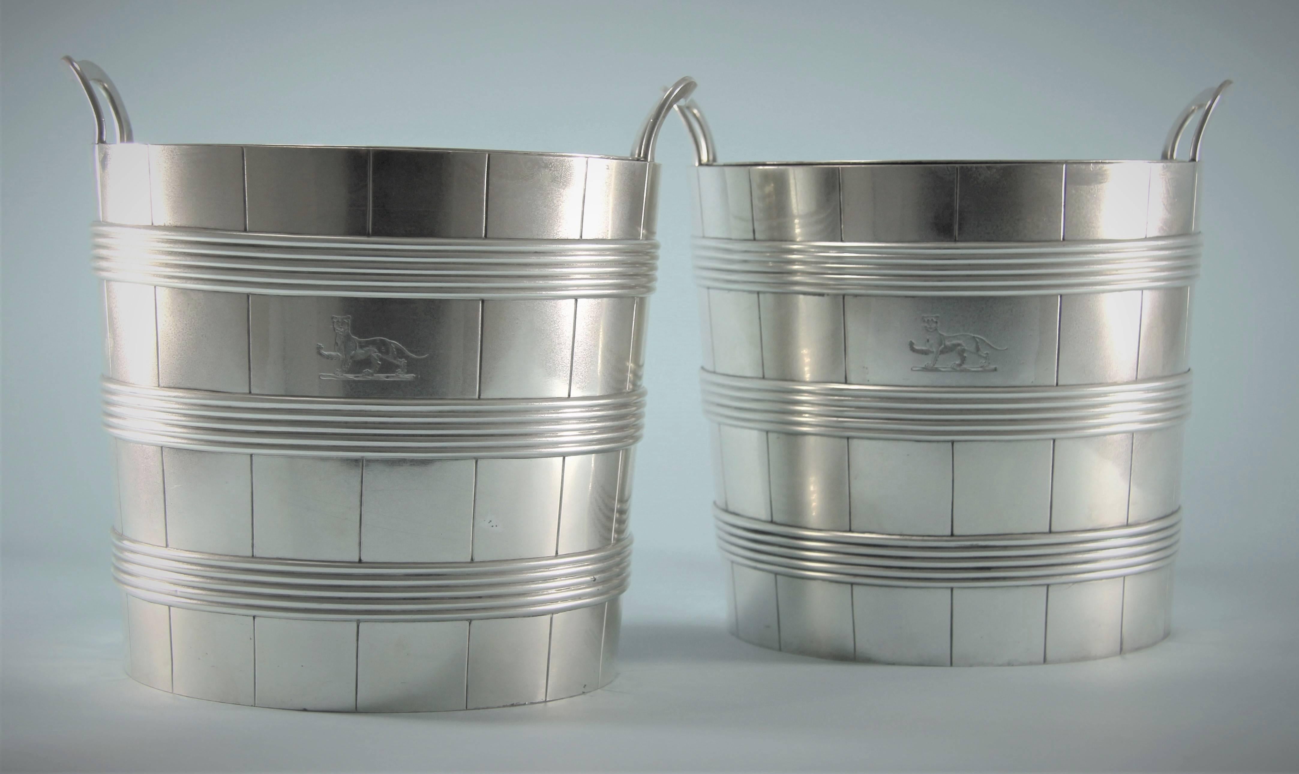 Smart and highly sought after pair of George III barrel shaped Old Sheffield plate wine coolers,
circa 1810-1820. 

These wine coolers are complete with a removable lead liner held in place by an Old Sheffield plate collar.
A contemporary family