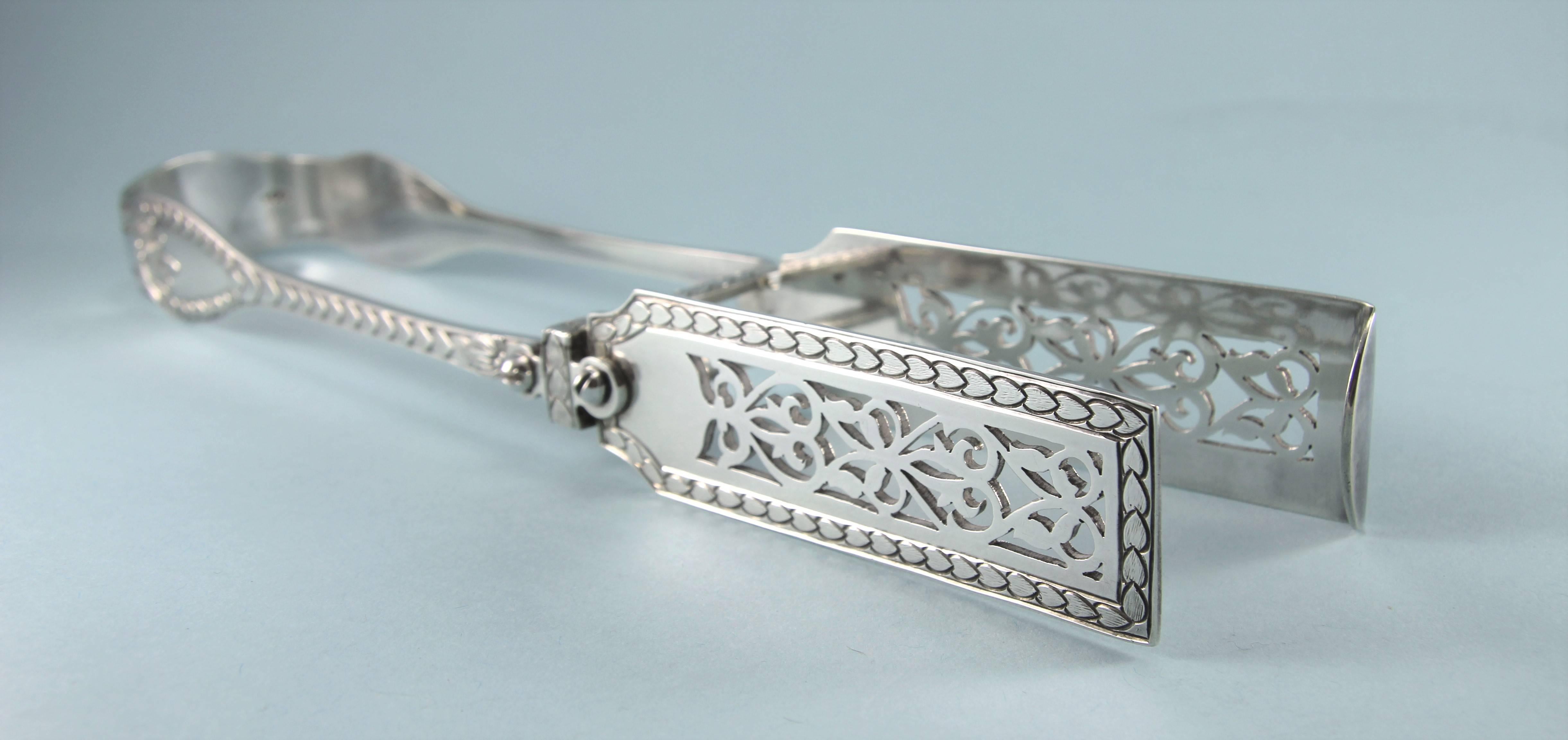 Very rare Palm patterned sterling silver asparagus tongs made in London in 1878 by George Adams. 

The bright-cut palm design stands out well against the plain silver background. 

The end of the tongs is engraved with a contemporary family