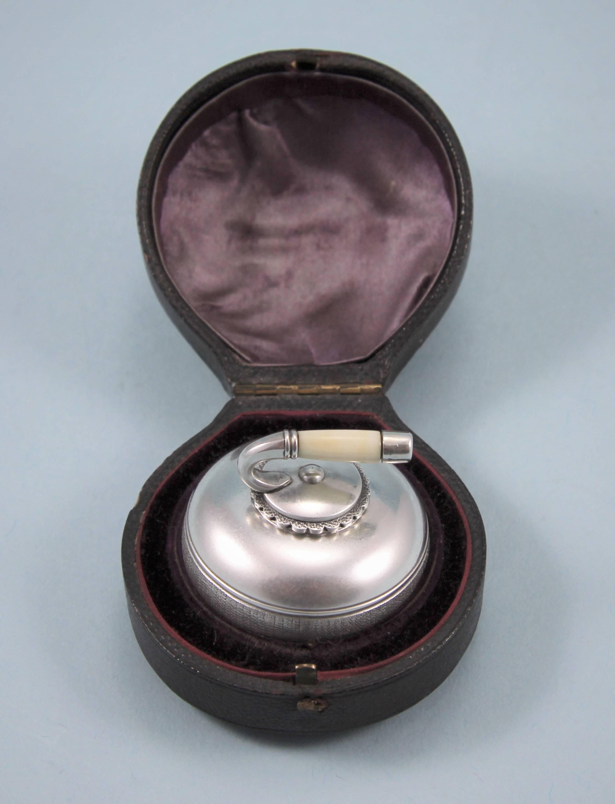 Amusing Victorian cased novelty box in the form of a curling stone with a silver and ivory handle.
Maker: Fenton Brothers. Sheffield, 1884.

The lid opens with a bayonet motion and the inside of the lid is clearly hallmarked with the maker's