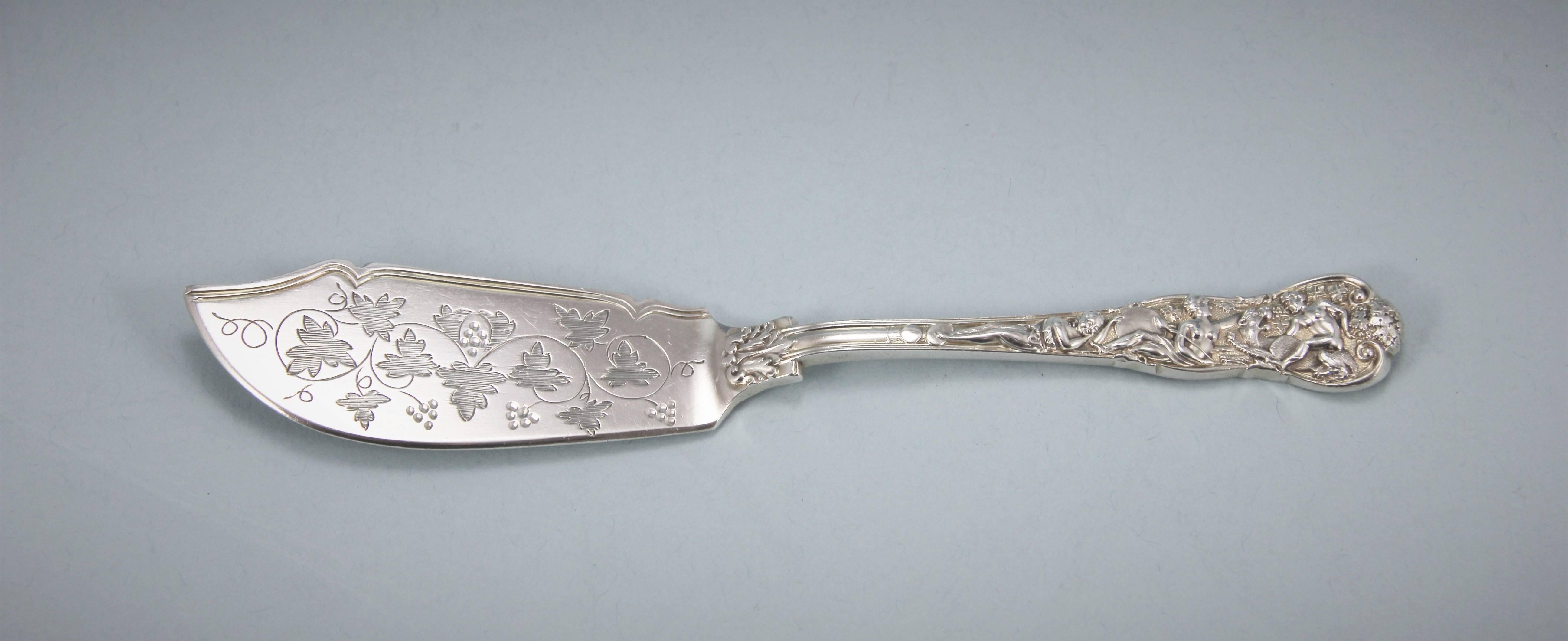 Highly decorative Victorian sterling silver Bacchanalian pattern butter knife. 
Makers: Lias Brothers - Henry John & Henry John Lias, London, 1869. 

The blade is decorated on the front with bright cut vine leaves and bunches of grapes and the