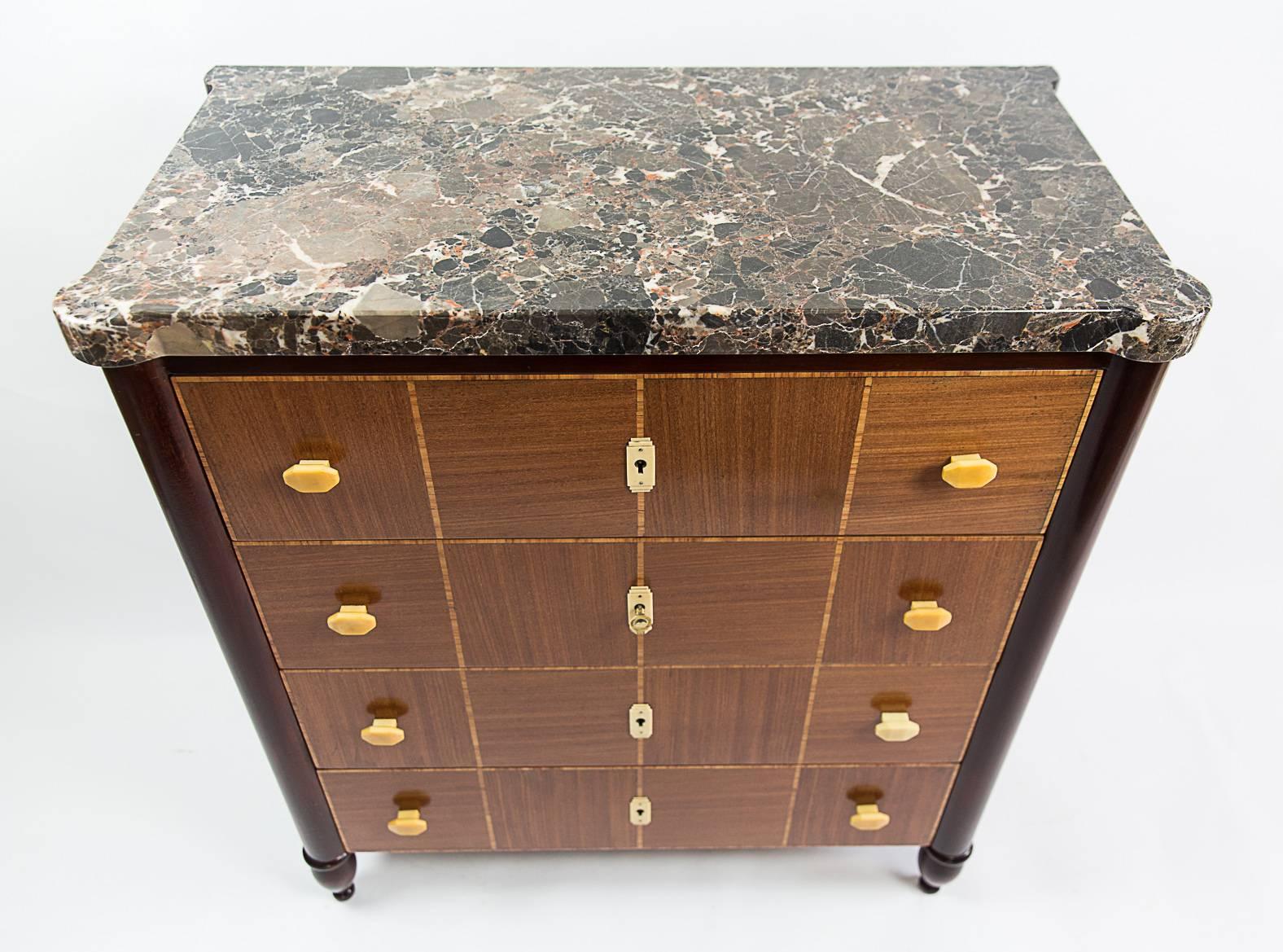 A very refined Art Deco commode attributed to Maurice Dufrène. Made of satinwood and rosewood placage with a very thick marble top.