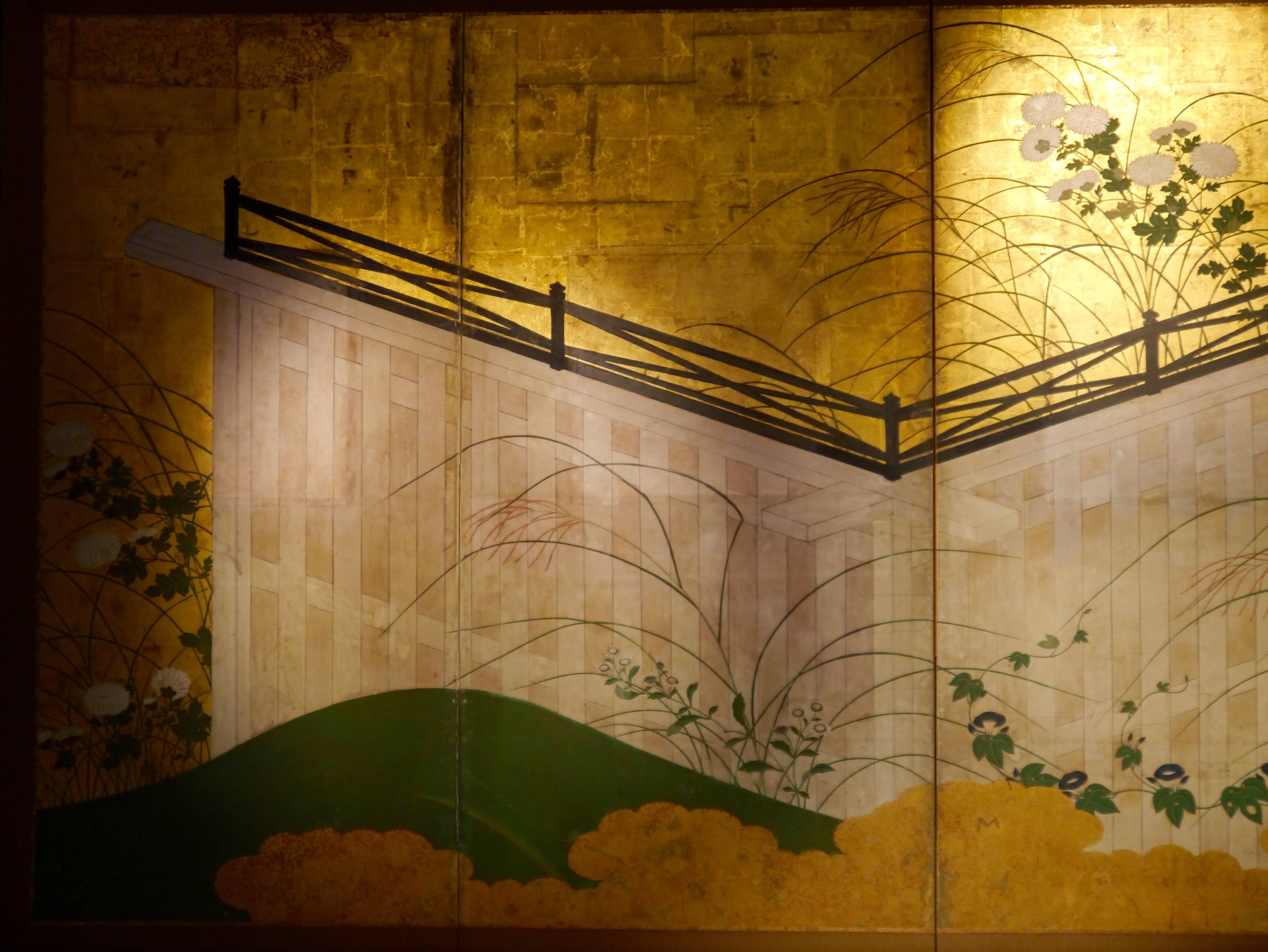 Four panels Japanese screen with wooden fence. Smooth hill covered with white chrysanthemum flowers and morning glory flowers on gold paper.