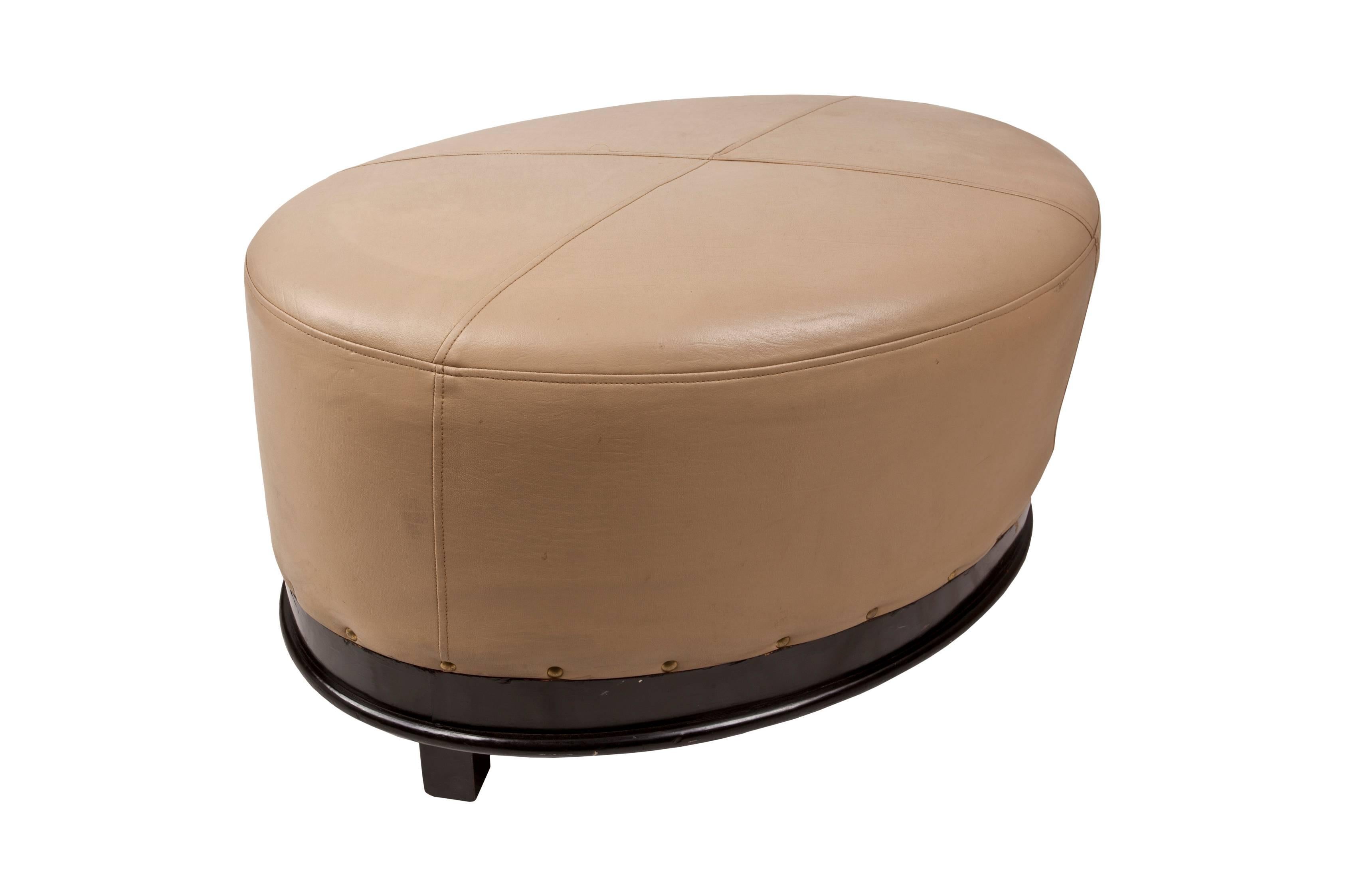 Fabulous pair of tan leather ottomans dating to the 1940s. Nice stitching design on the top, brass rivets along the bottom edge and in excellent condition. True color are the professional photographs, the close-ups are slightly over exposed.

 