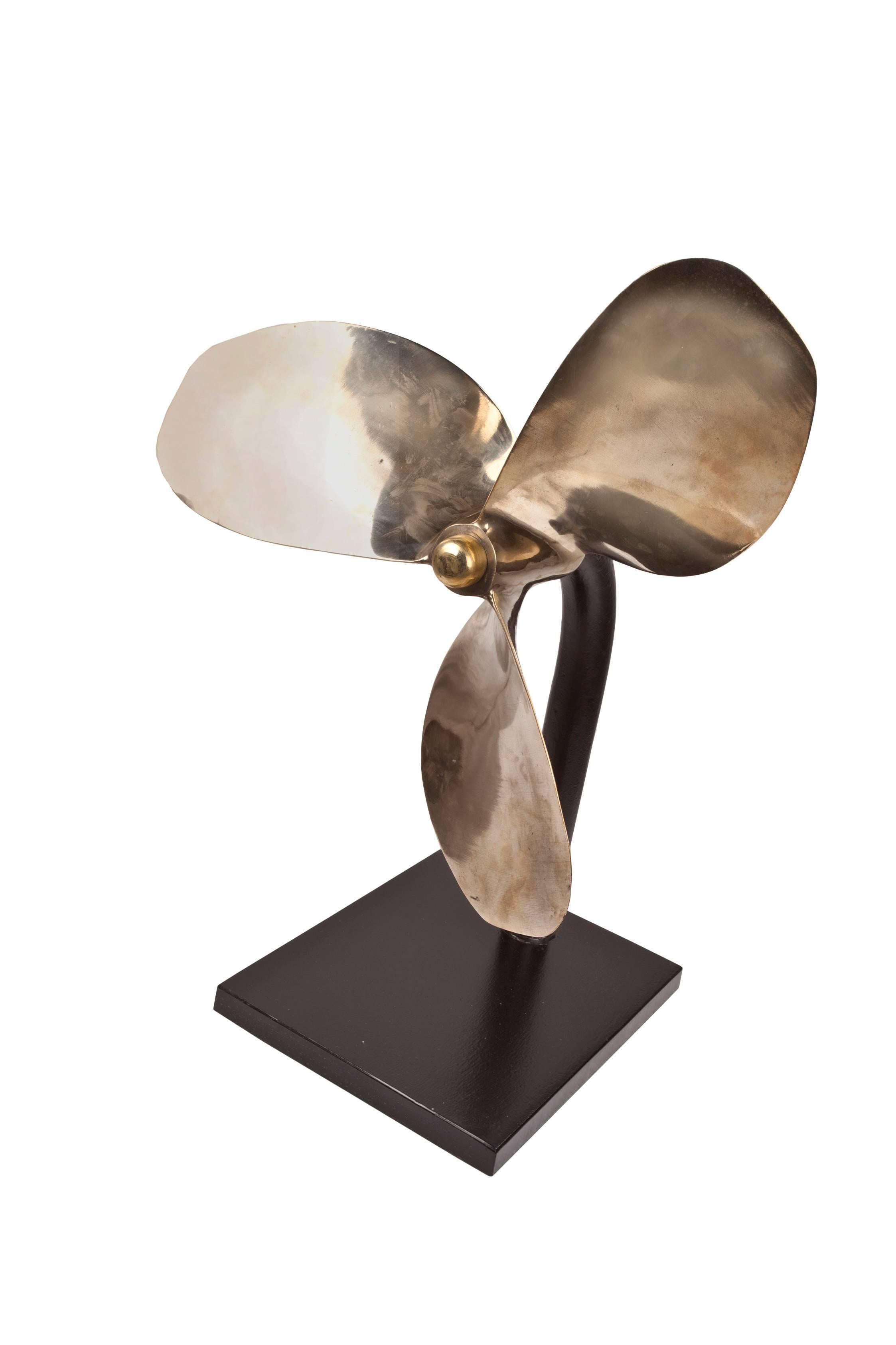 Large bronze propeller from a decommissioned lifeboat. Great scale and patina. Mounted on a custom made iron stand. Makes a wonderful sculptural piece with a history, 1970s. The base measures 12