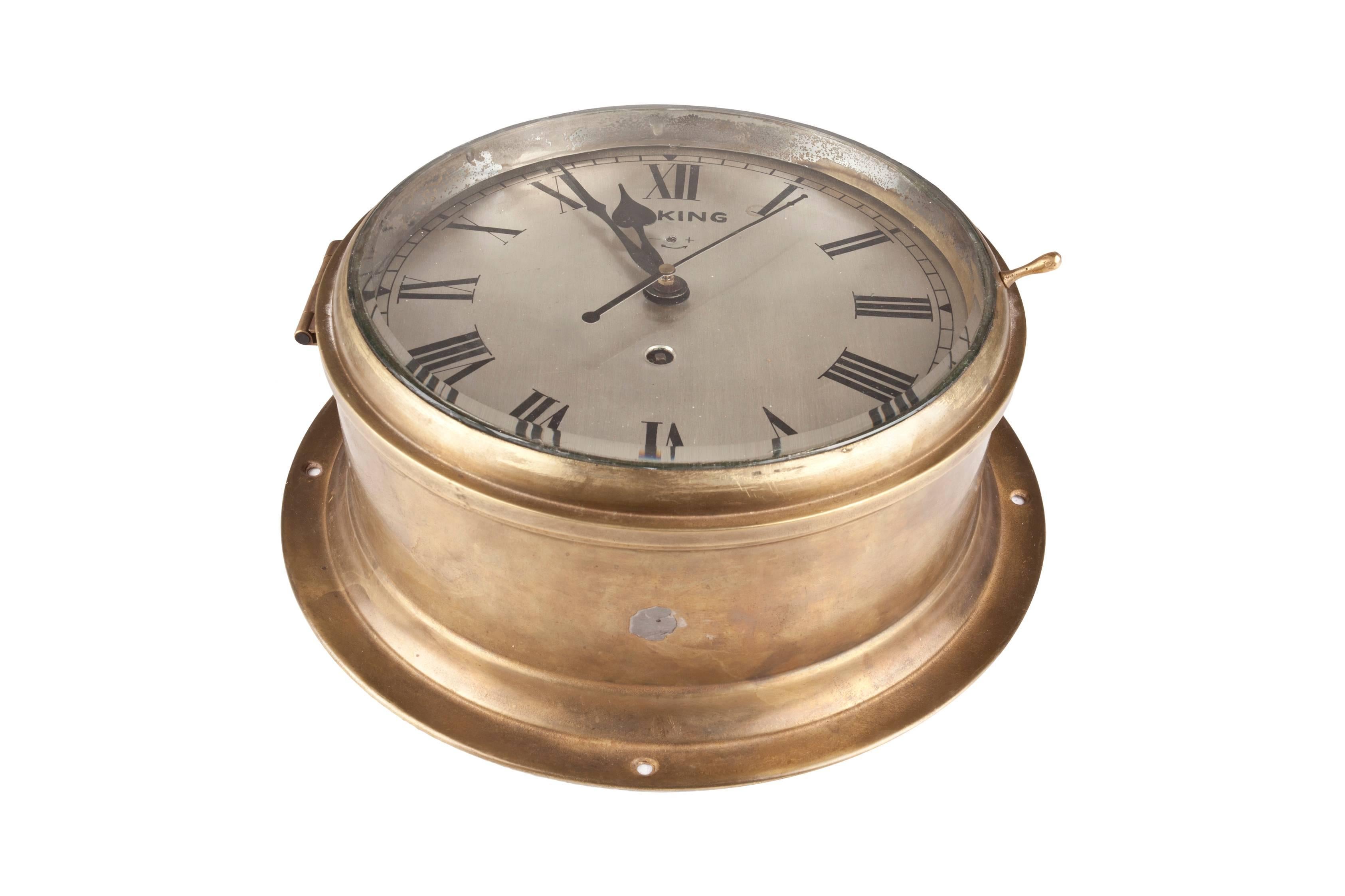 A handsome ship's clock in a brass casing with nickel face and roman numerals. Signed Viking. This is a spring mechanism clock which you wind every 8 days. In excellent working order. Easy to mount on the wall or place on a stand, circa 1960,