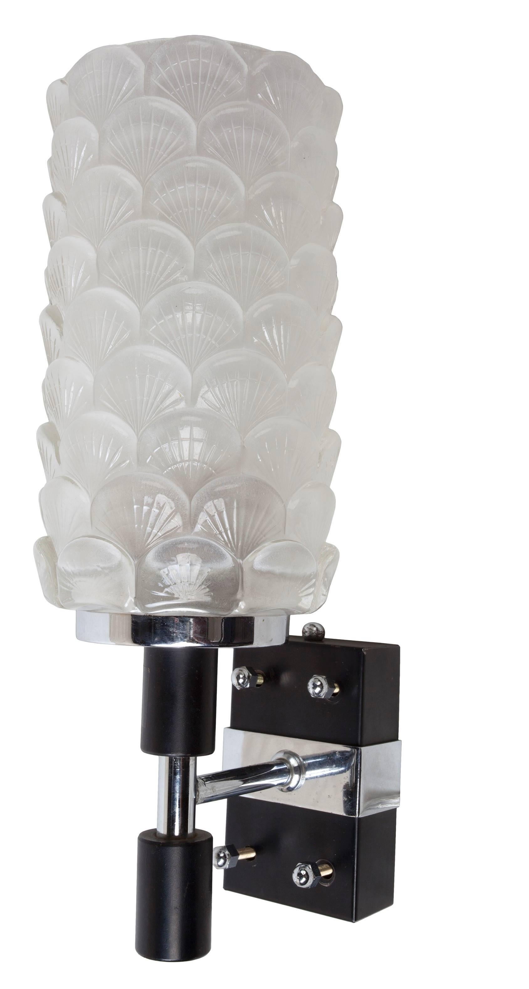 A pair of exquisite deco-period glass sconce shades with shell motif on chrome and black metal backplates. Rewired for American use, porcelain socket and takes a regular size light bulb. European. As of this writing I have two pairs.

Base