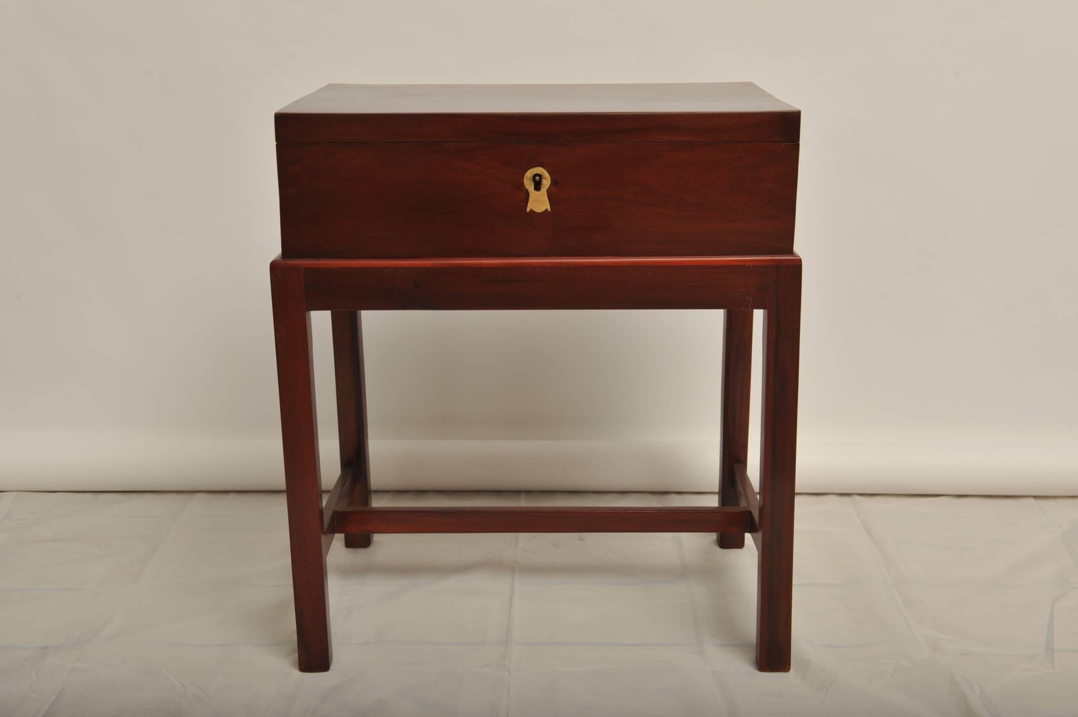 Late 19th century British Campaign mahogany officer's chest on custom-made mahogany stand. Brass handles, fitted interior with secret compartments. Simple and elegant, designed to use as a side table. Restored.