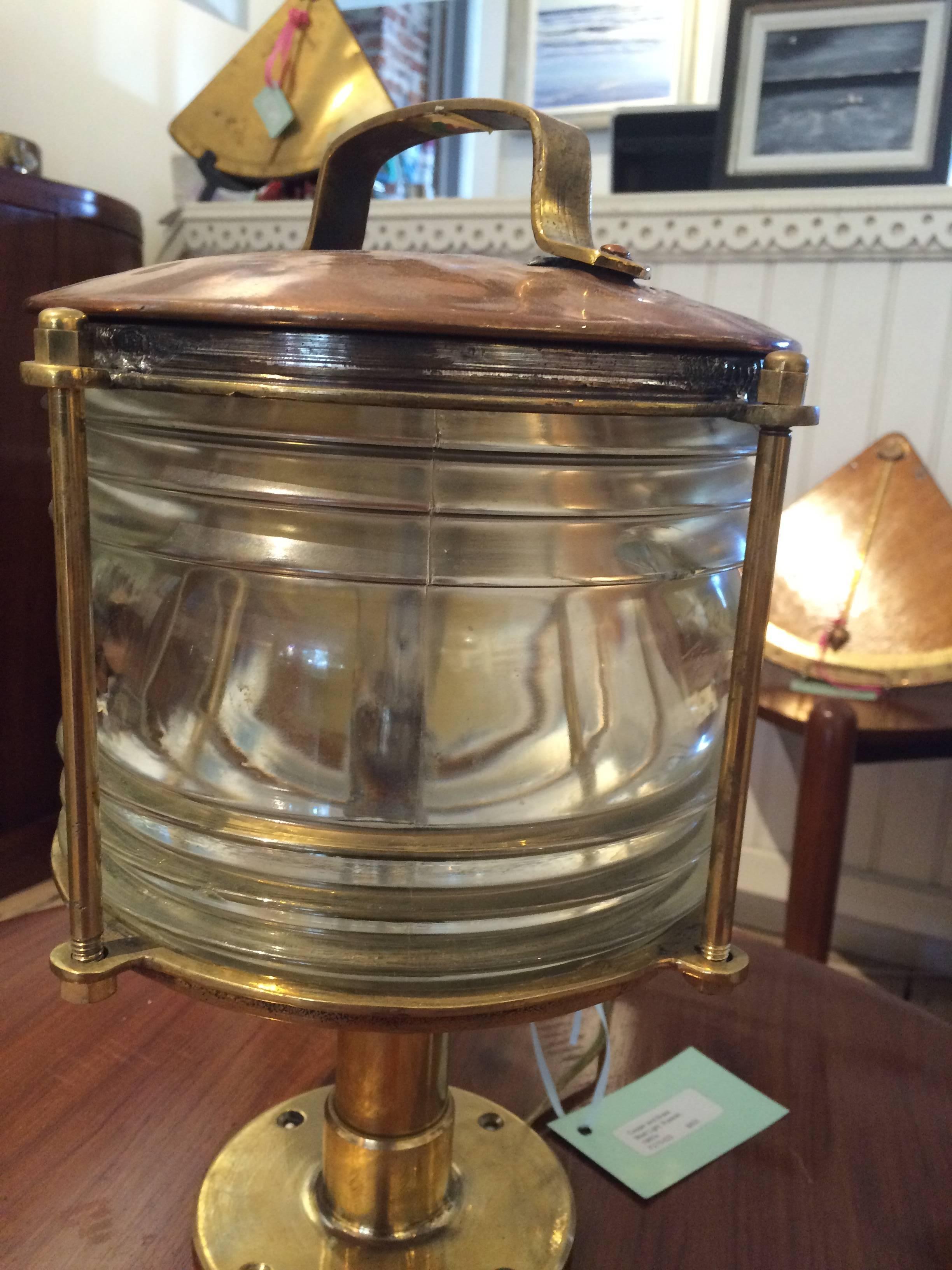 Handsome Mid-Century ship's post light with Fresnel lens, made of copper and brass. Rewired for American use, and takes a regular size light bulb.

 