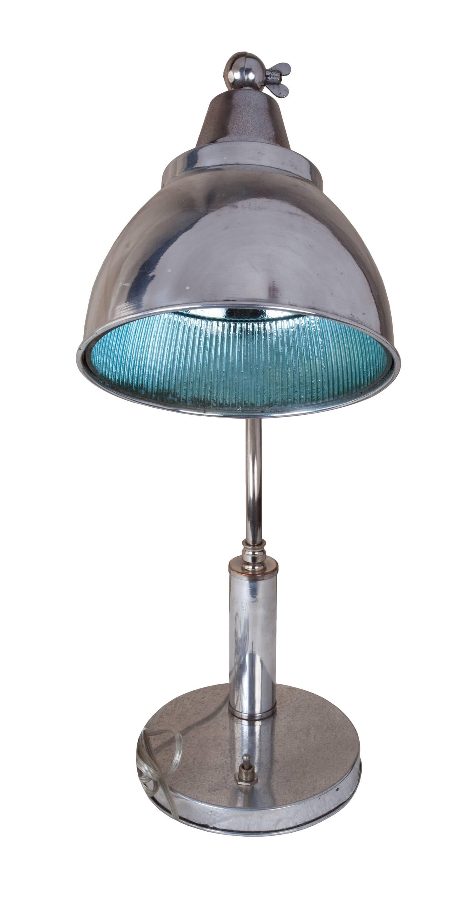 An adjustable ship's goose-neck table lamp in chrome from a Mid-Century merchant ship. The interior of the light's shade is glass-lined. It has been rewired for American use and takes a regular size light bulb. On/off switch at the base. Diameter of