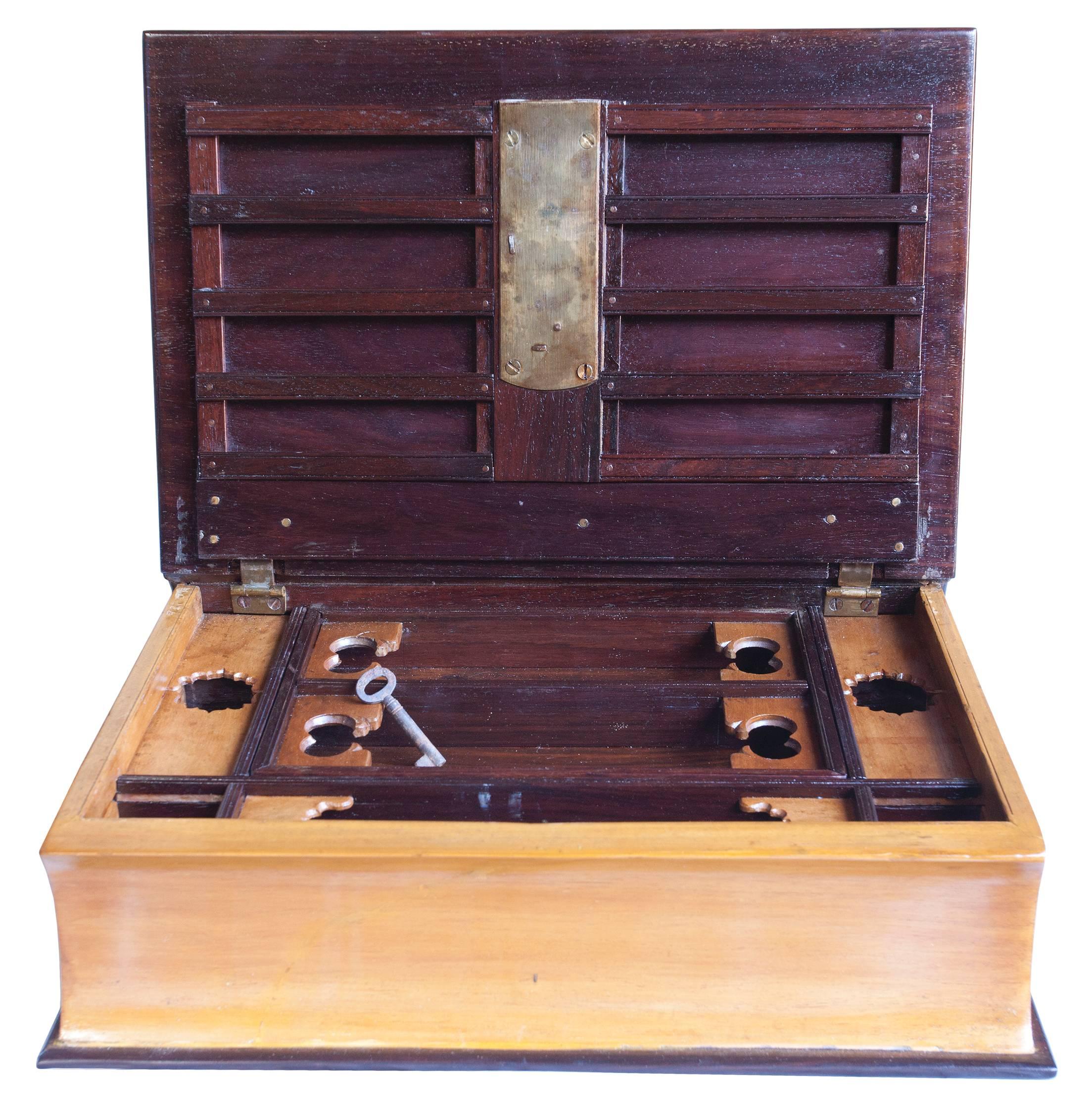 An early 1900s rosewood and satinwood book box with lock and key and intricate interior compartments. The interior tray lifts out for space underneath, documents and the like. Classy and discrete way to store and hide your valuables.