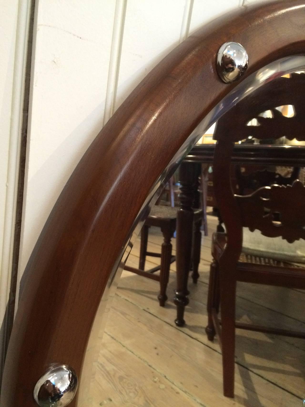 Large size ship's mirror made of teak with chrome rivets and beveled mirror. Great 3' diameter size. From a ship's stateroom. 

Nautical antiques located on Nantucket Island.