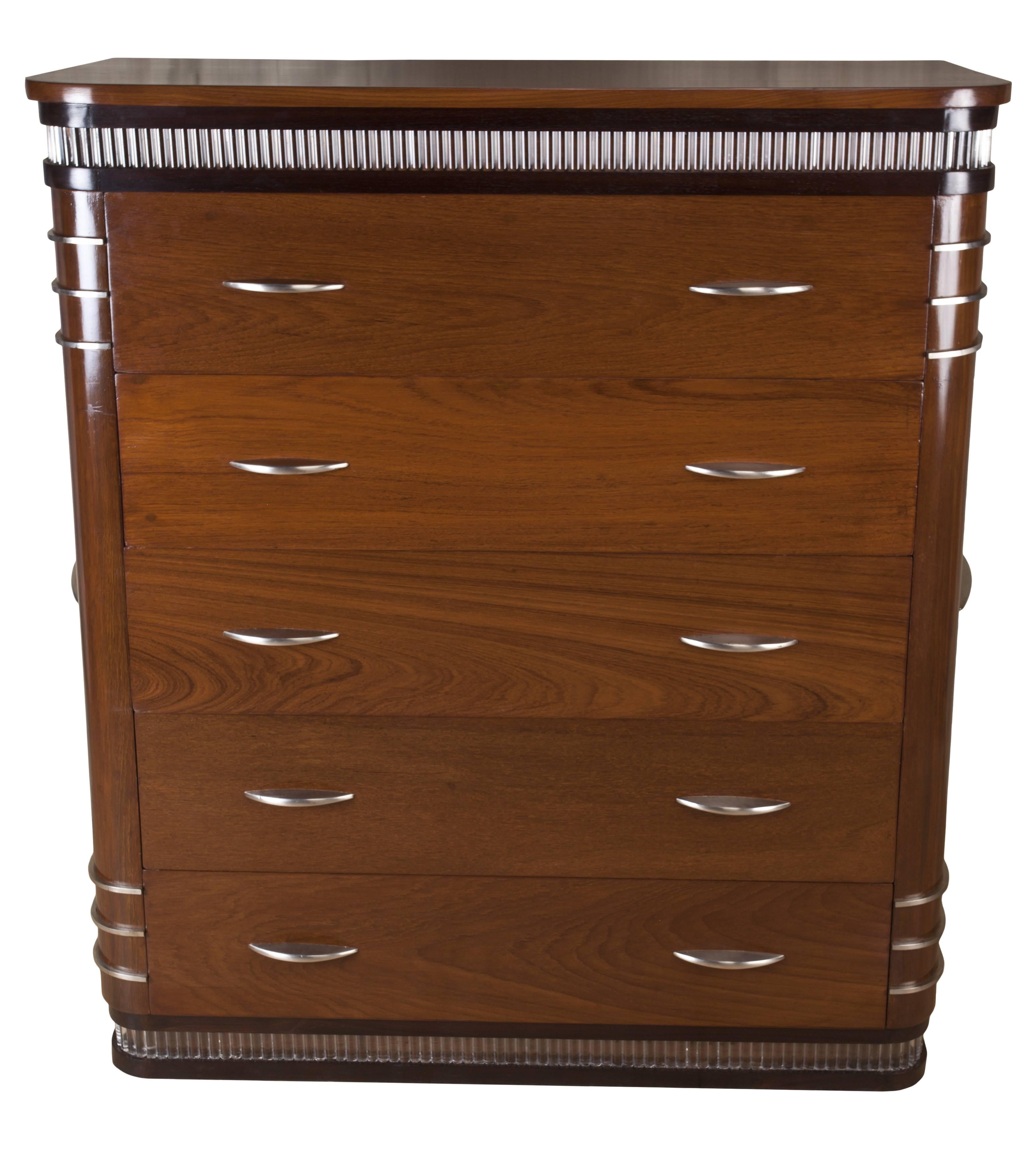 An amazing find, deco period teak chest of drawers with rosewood accents, glass inlay rods at the top and the bottom. Chrome features include drawer pulls, side detailing and handles. Rare and handsome.