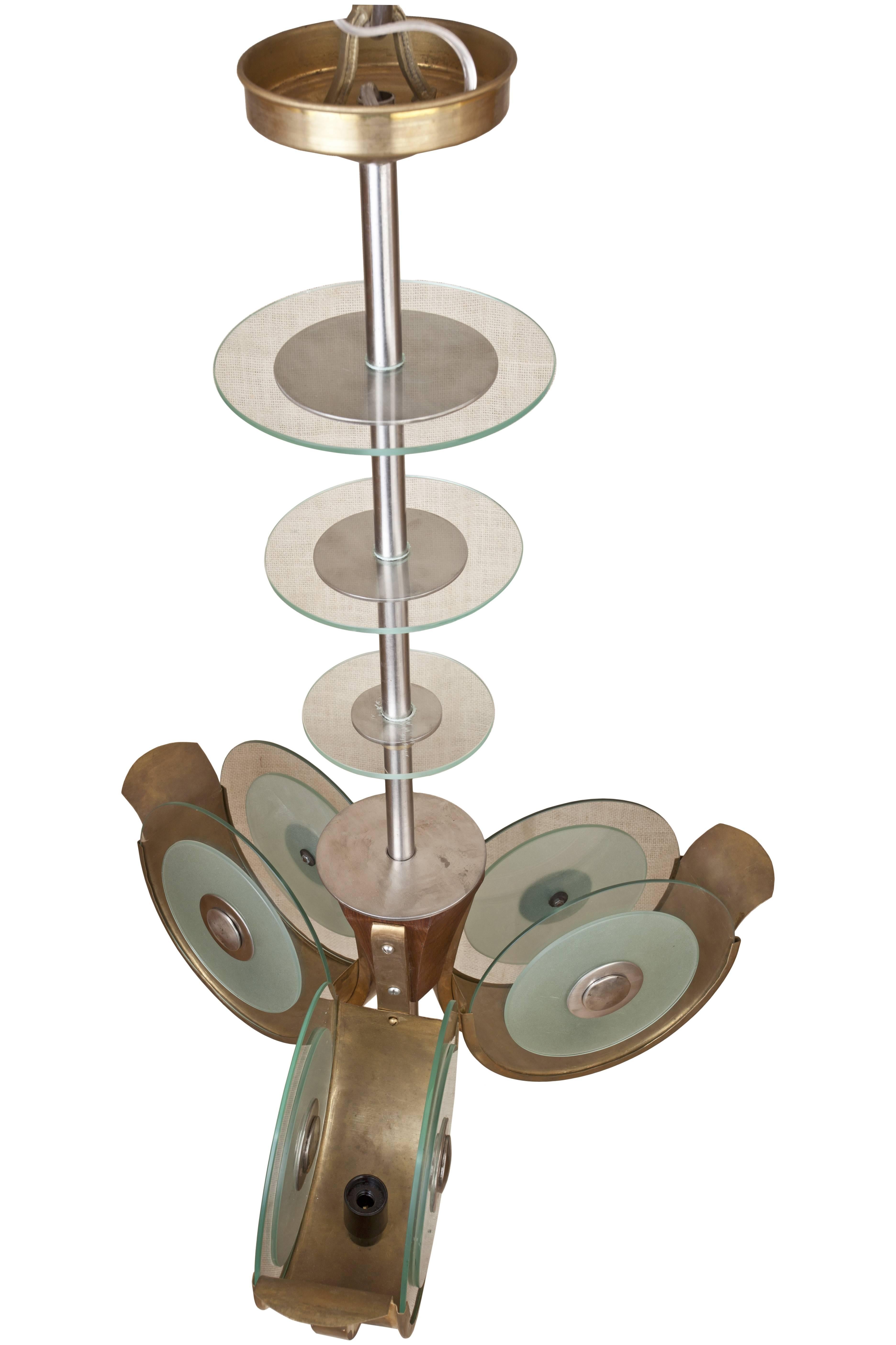 These are an incredibly rare find, reclaimed light fixtures from the Art Deco period Metro Goldwyn Mayer Theatre in Bombay. Frosted and clear glass, brass and teak three-arm chandelier. Each arm takes a candelabra bulb. Rewired for American