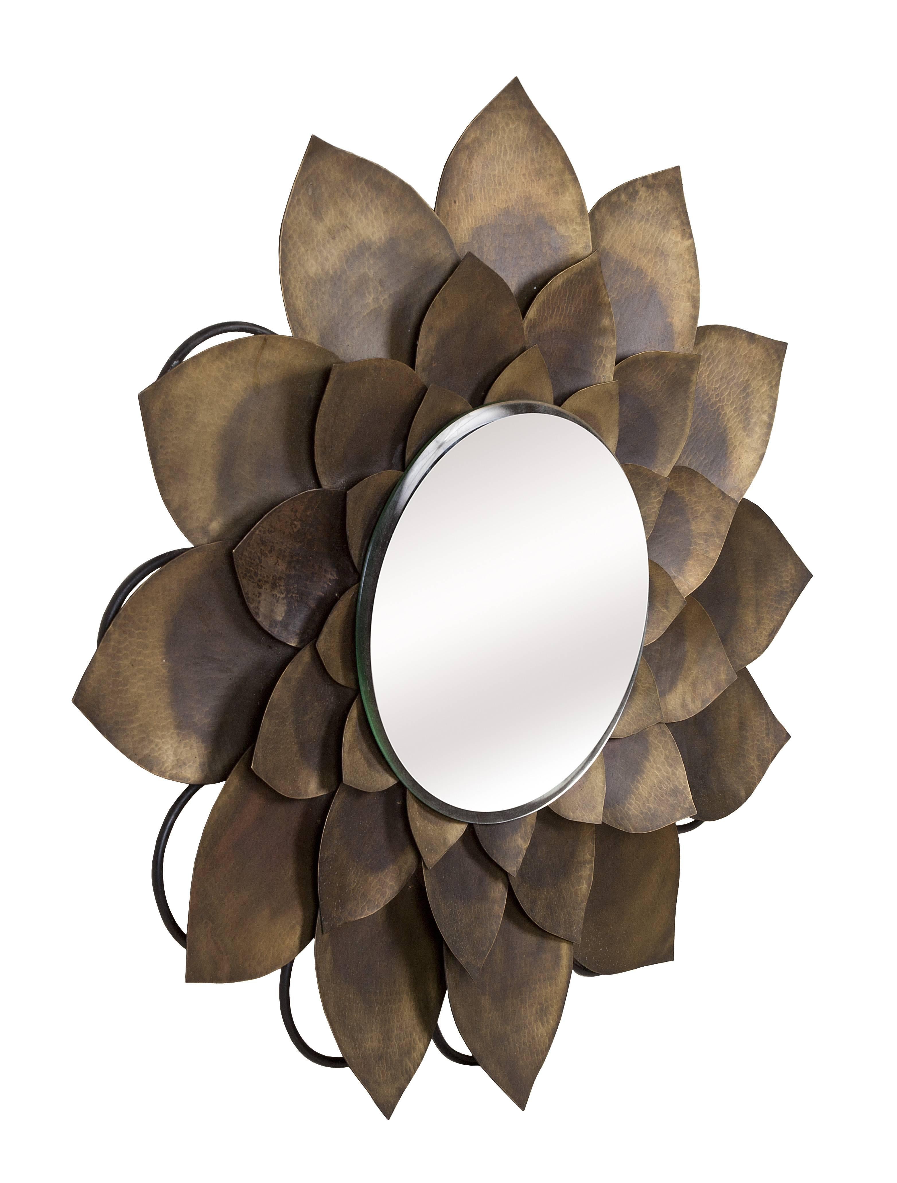 Such a cool and rare find. This hand-hammered lotus flower mirror with beveled glass dates to the 1960s. Wrought iron framework on the backside makes it easy to hang. This is quite special. The mirror glass diameter is 14 inches.