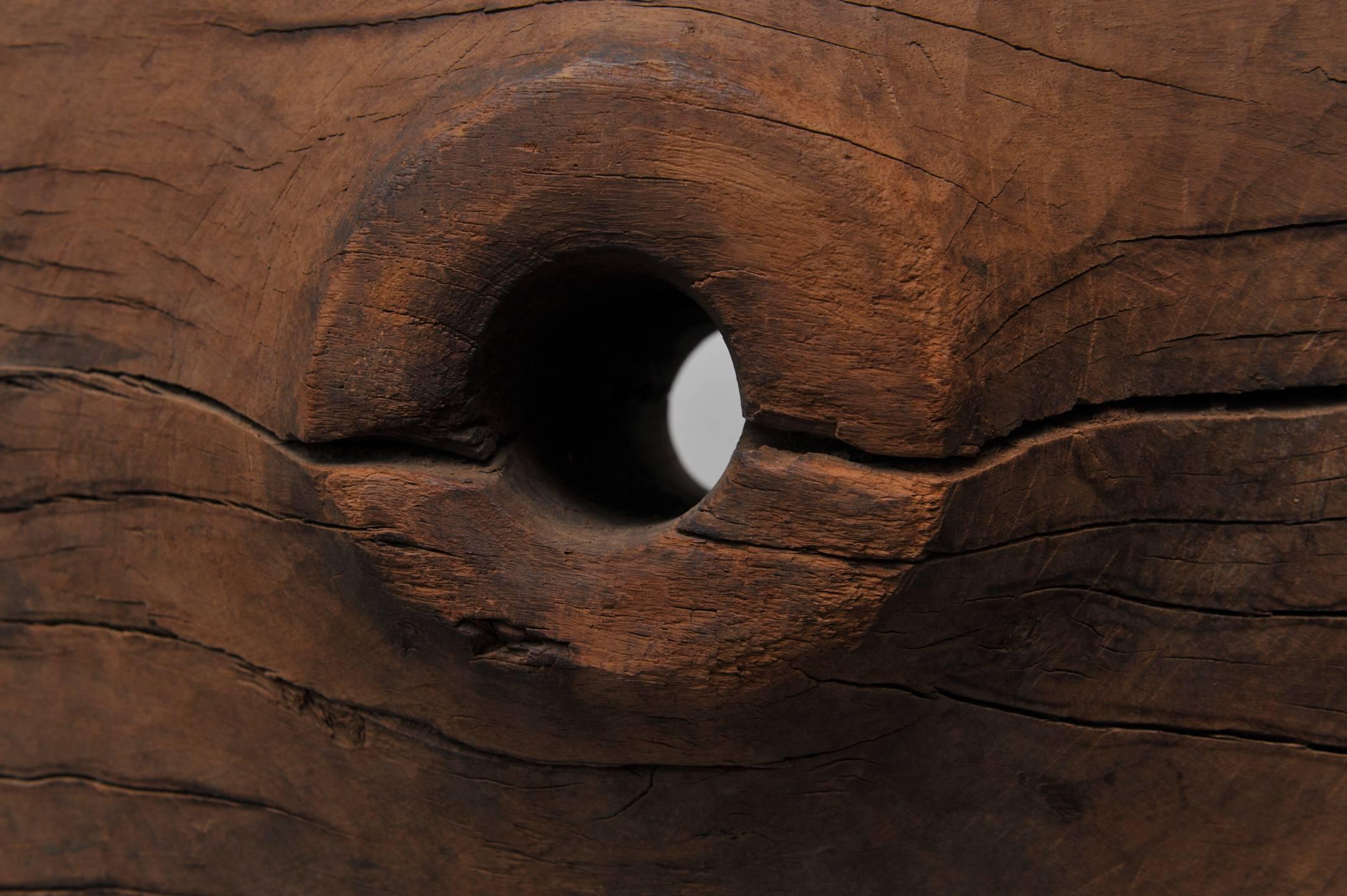 A late 19th century teak ox cart wheel converted into a sculpture. Originally from Southeast Asia, the piece as a sculpture had a once functional history but now offers itself as an interesting zen -like artifact to your home or office. It has a