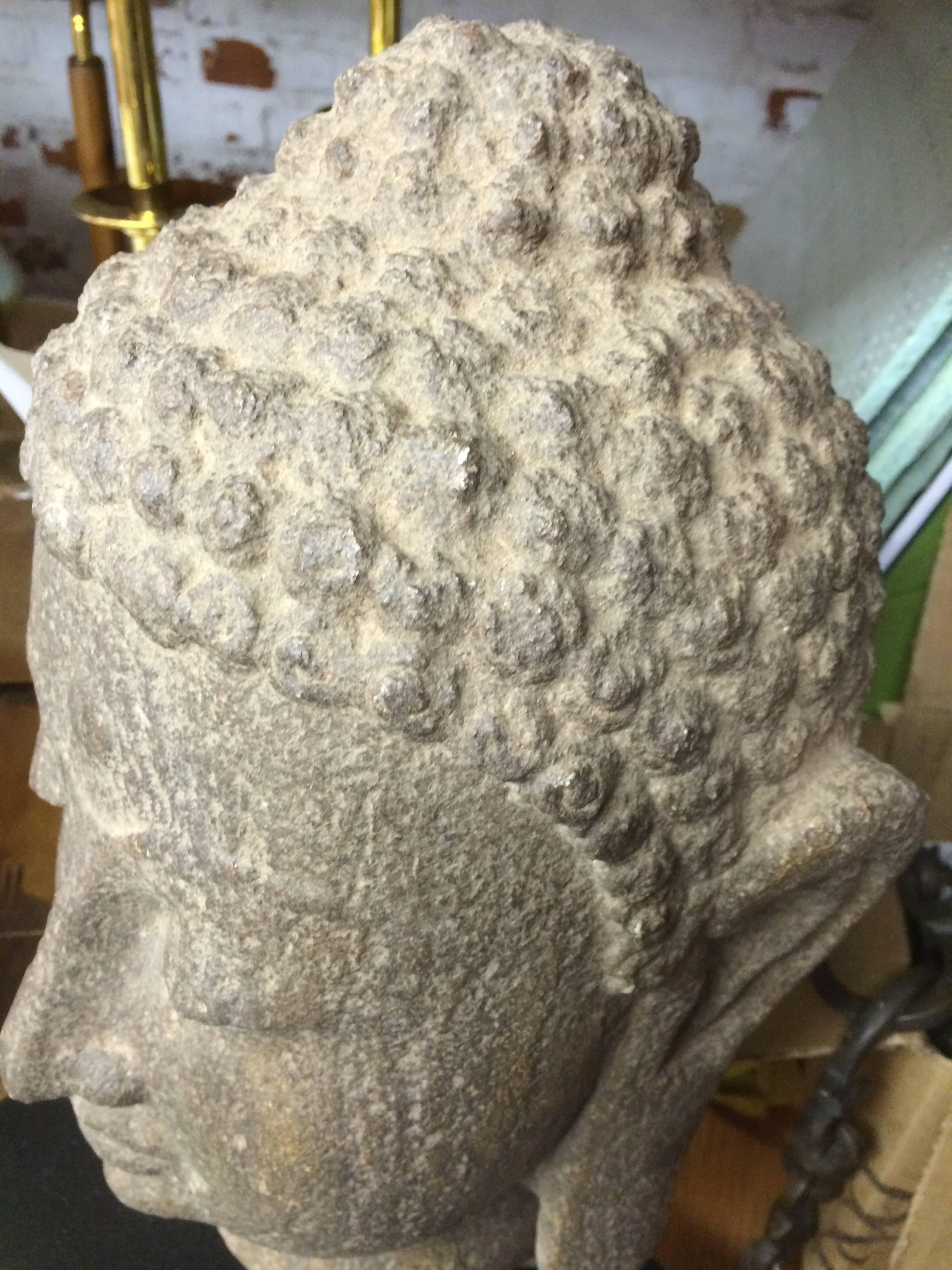 A beautiful Buddha head made of granite dating from the 19th Century. Features include the typical curled hair, elongated ears and half-closed eyes. The Ushnisha crown depicts the wisdom and illumination after attaining enlightenment. In excellent