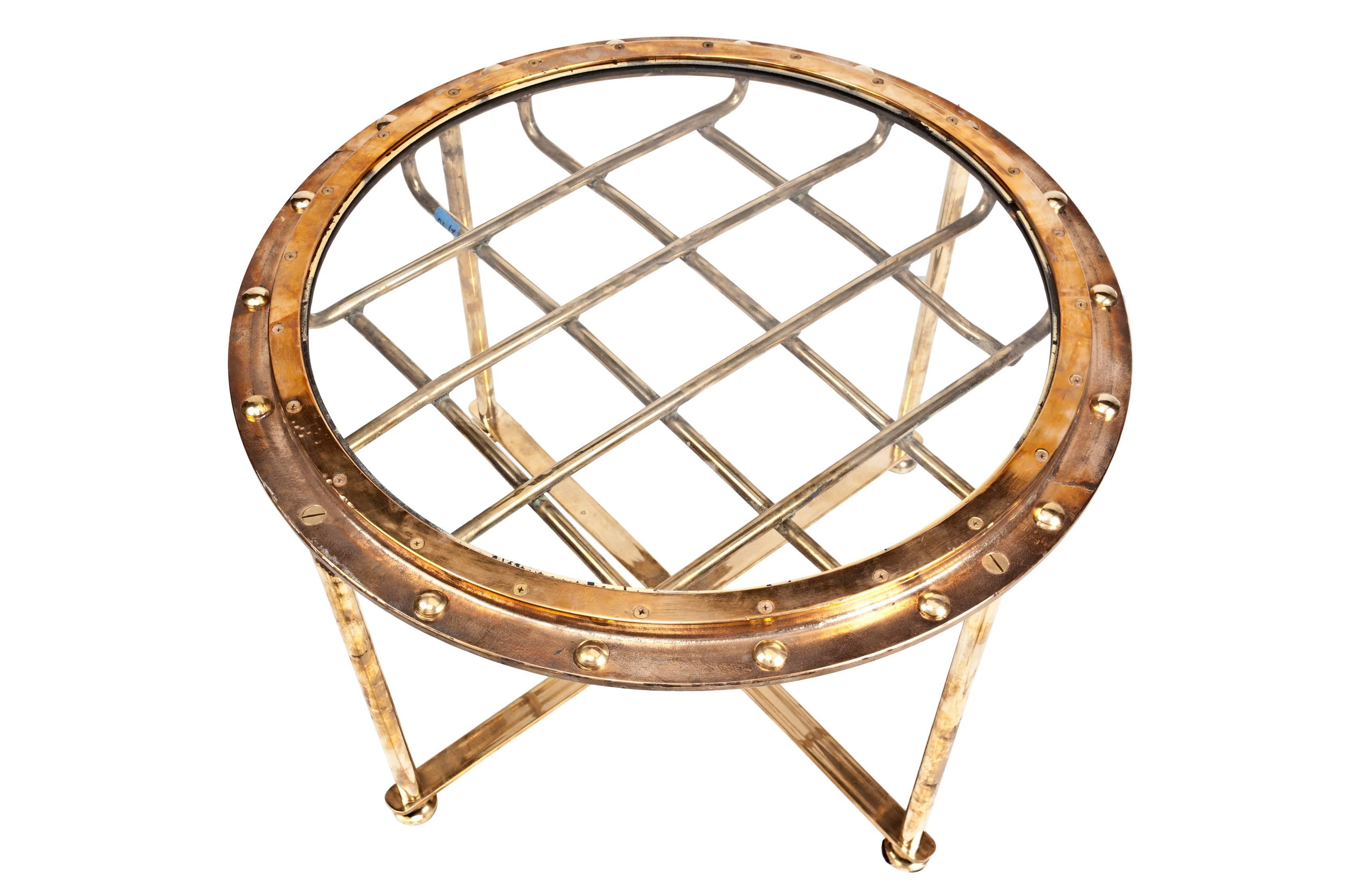 This is a rare find these brass porthole ship windows with the exterior protective brass grid. I had them converted to tables using my own custom design. These are designed to come apart for easier transport and have had the brass rivets put back in
