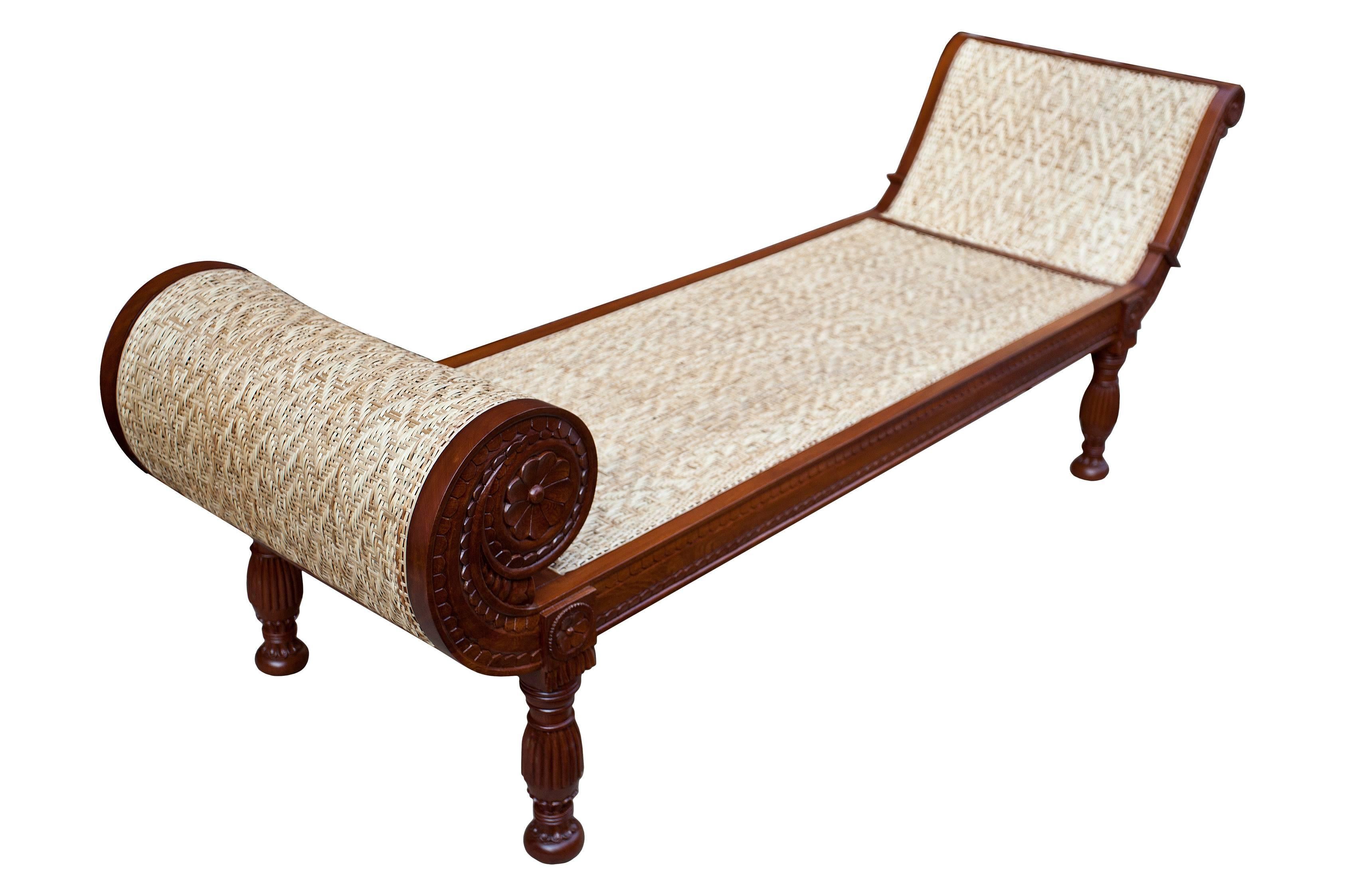An exceptional piece, mahogany with finely carved details and tightly woven caned seat (redone) in a diamond design. Rolled end on one side and a custom-made three inch cushion with bolster and two pillows done in a silk linen, mid-late 1900s.