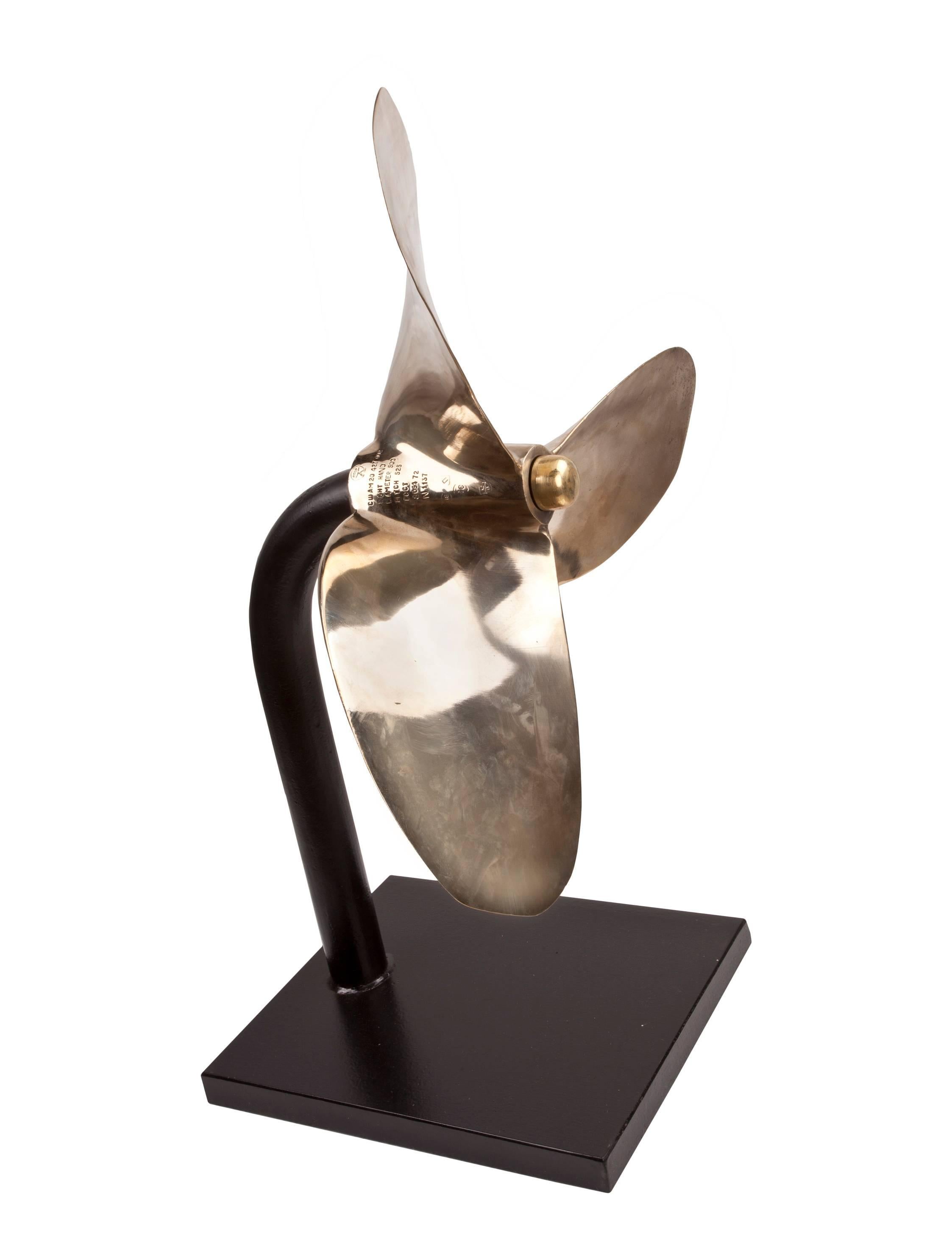 A recovered propeller from a ship's lifeboat (and not the rubber raft variety). Exceptional large size and makes a beautiful sculpture, circa 1970s. Industrial, soft and elegant all at once. Stand is custom-made and the prop can be taken off. The