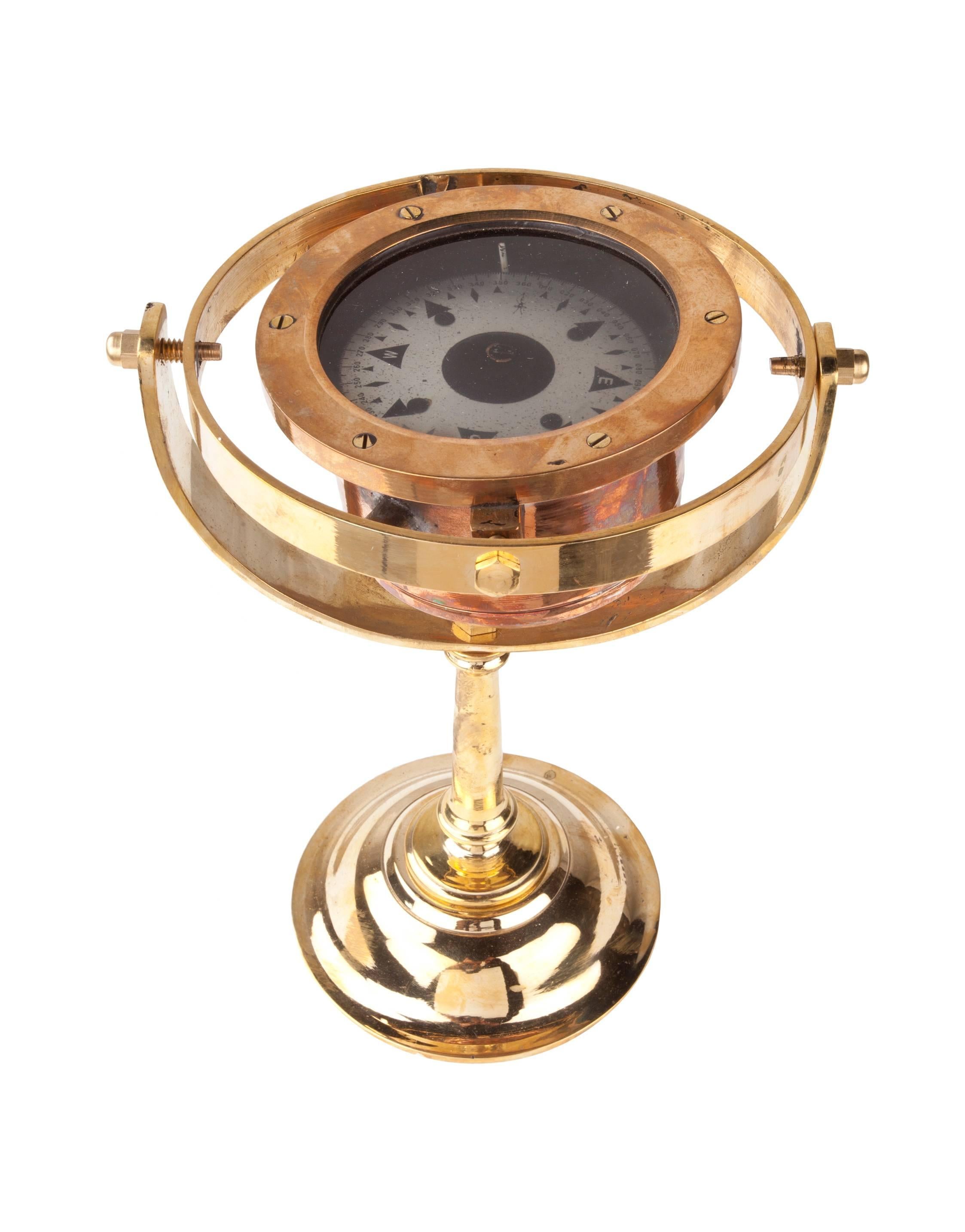 A working compass from a ship's lifeboat, circa 1960s. Gimbaled frame with a nickel face plate on a custom-made Y-shaped Stand. Rescued from it's wooden box, polished and ready for display. Compass itself is 4.75 inch diameter.

Nautical Antiques