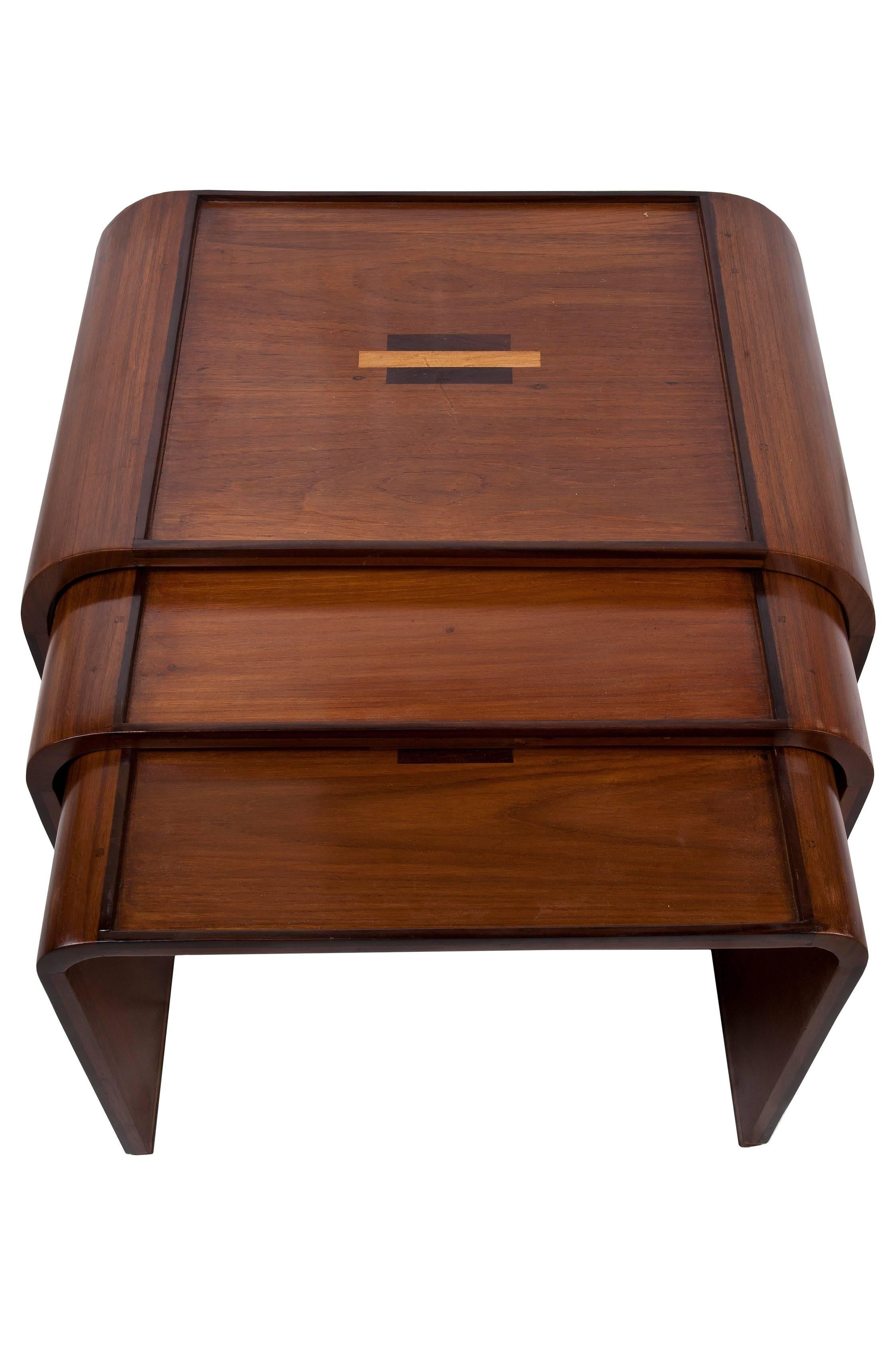 A set of Art Deco mahogany nesting tables with teak and rosewood inlay, late 1940s. Listed measurements are for the largest table, others are 22.5