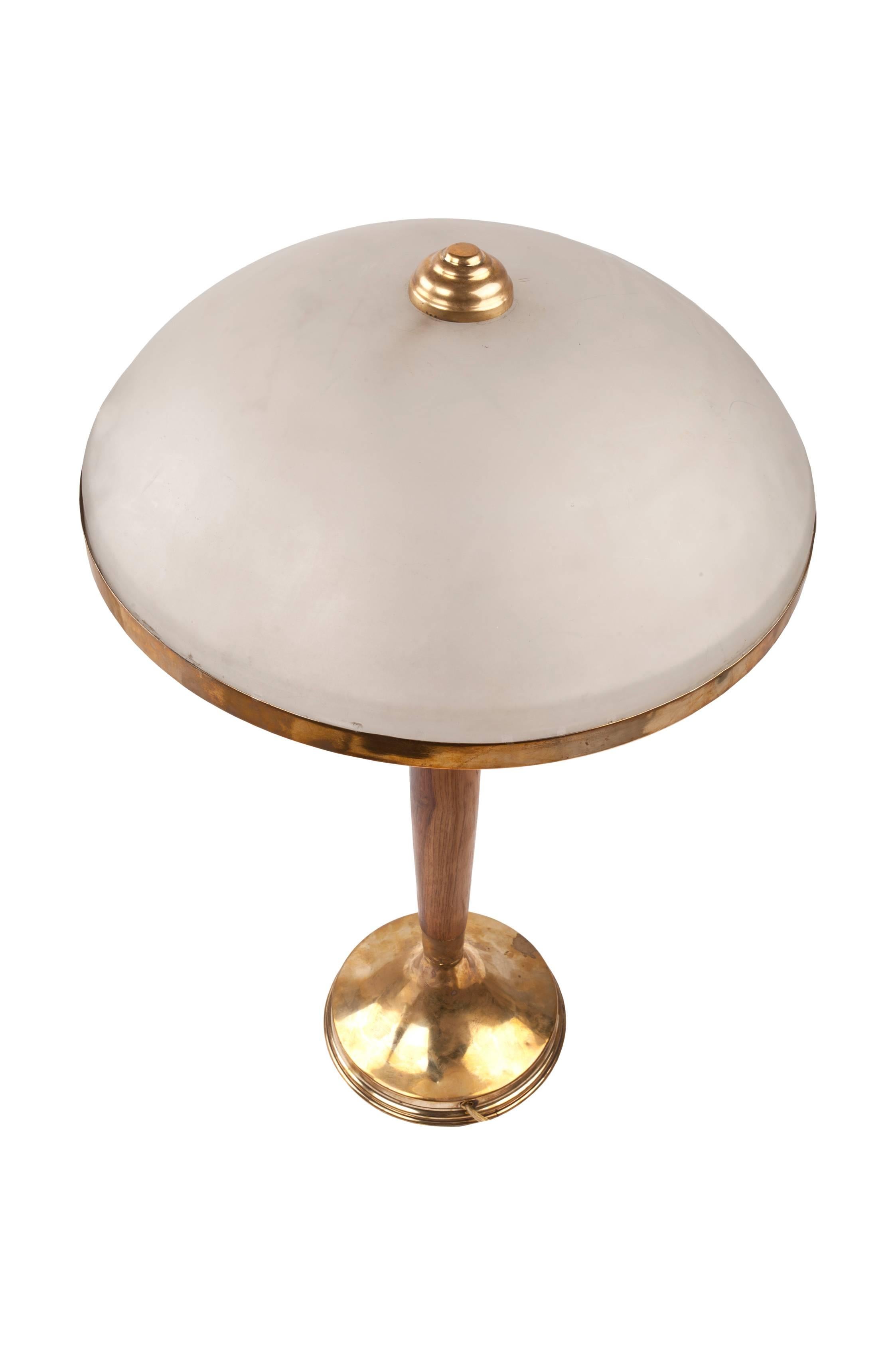 Elegant teak and brass table lamp with opaque glass shade. Originally European, this takes an E-14 bulb base, and those are easy to find. Rewired for American use. Mid-Century Modern. Base measures 7 inches, shade height is 5 inches, and stem is