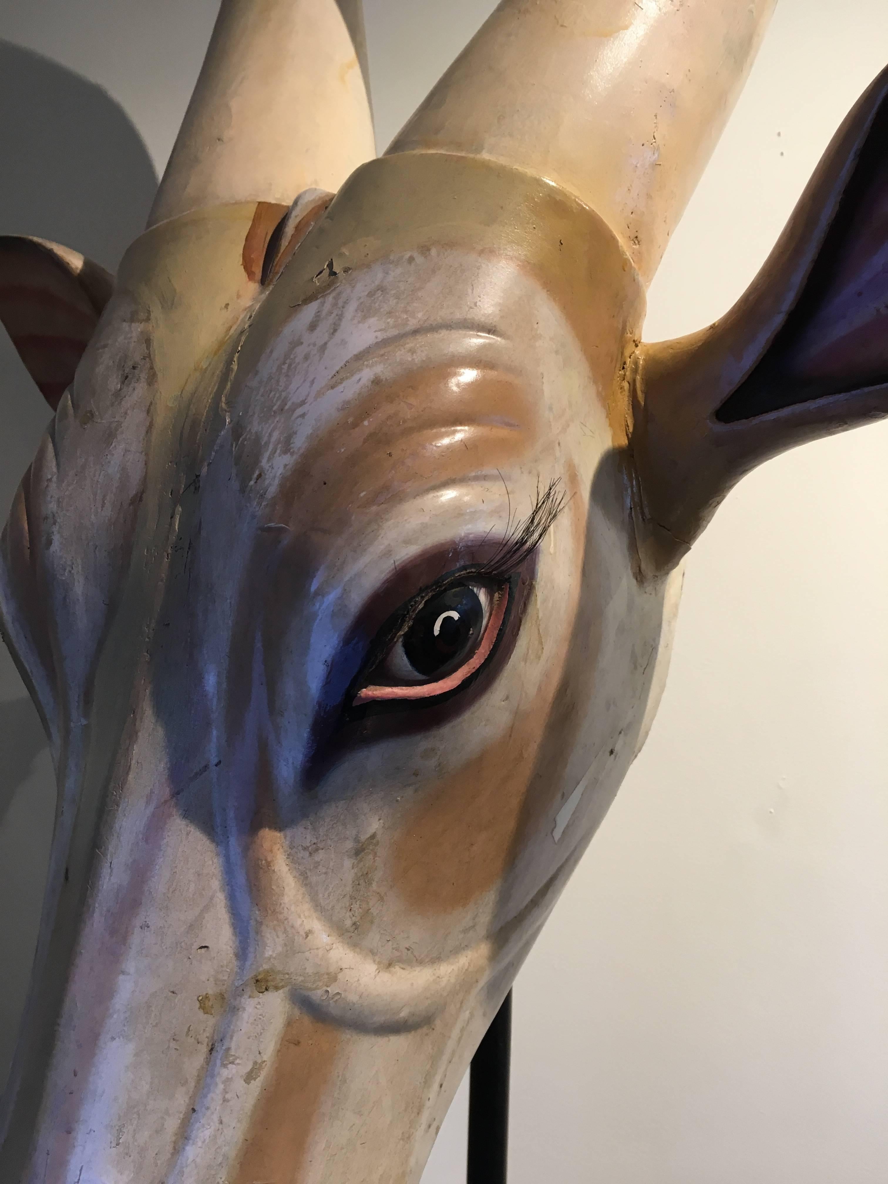 This is a stunning and lovely carved wood, Folk Art mask of a Brahman sacred cow used in South India during ritual parades. Original gesso paint and eye lashes. Early 1900s. This can be hung on the wall or used with its custom-made Stand. The