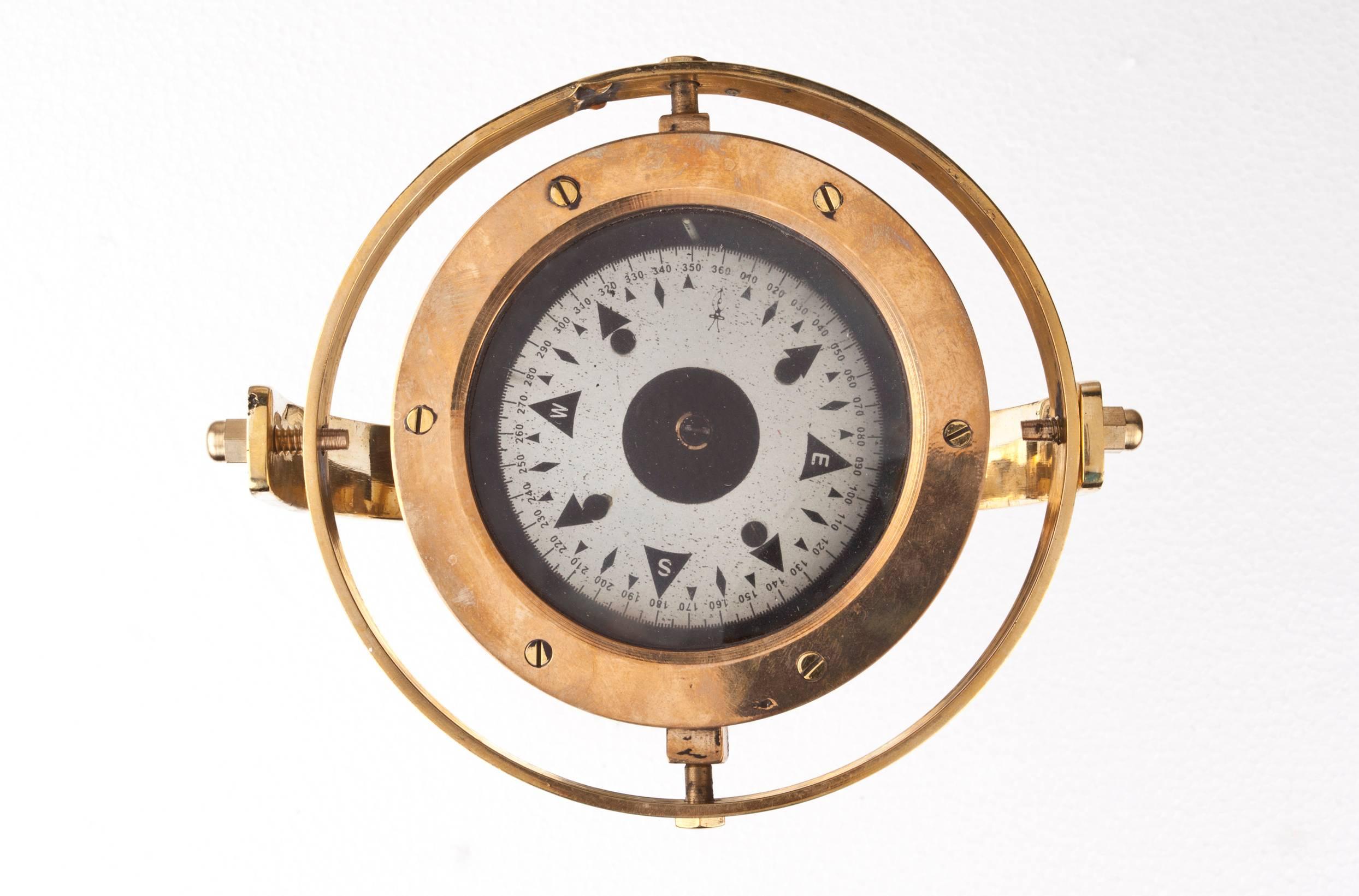 These brass lifeboat compasses are often held in a closed box. I had this polished and designed a custom brass gimbal stand. Makes a great desk accessory and in working order with a nickel face plate, circa 1970s just the compass without the stand