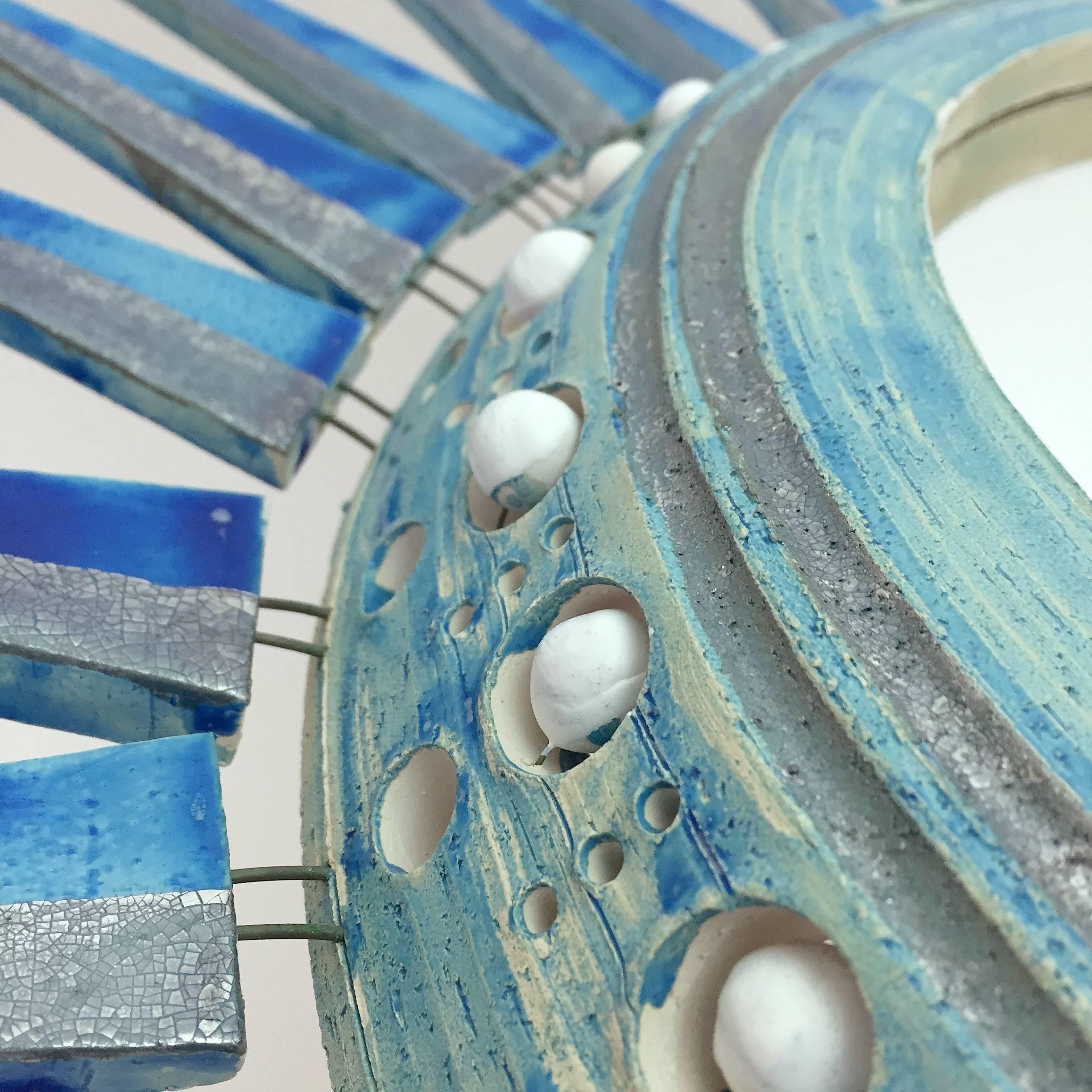 Important ceramic mirror, half glazed and enameled in shades of blue, turquoise, white and crackled silver. 
One of a kind piece in these blue color tons. 
Impressive one of kind piece, handmade by the French ceramicist, based on his genuine models