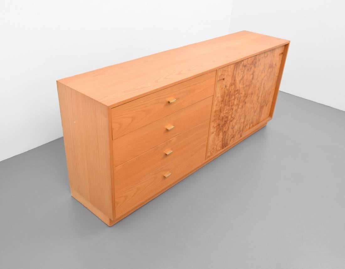Burl wood credenza by Harvey Probber.

Cabinet has four drawers and two doors revealing two adjustable shelves.