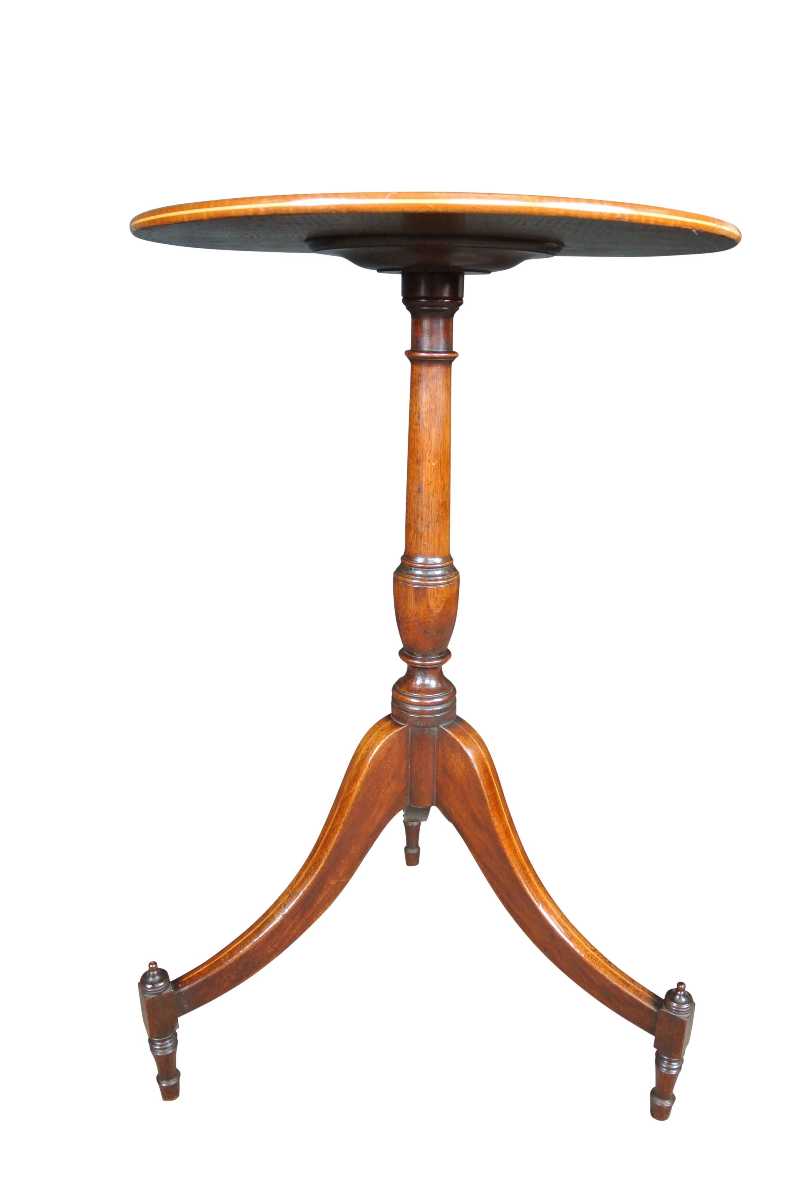 A very fine George III Sheraton period Fiddleback mahogany wine table with a turned stem on a tripod base ending on toupie feet.