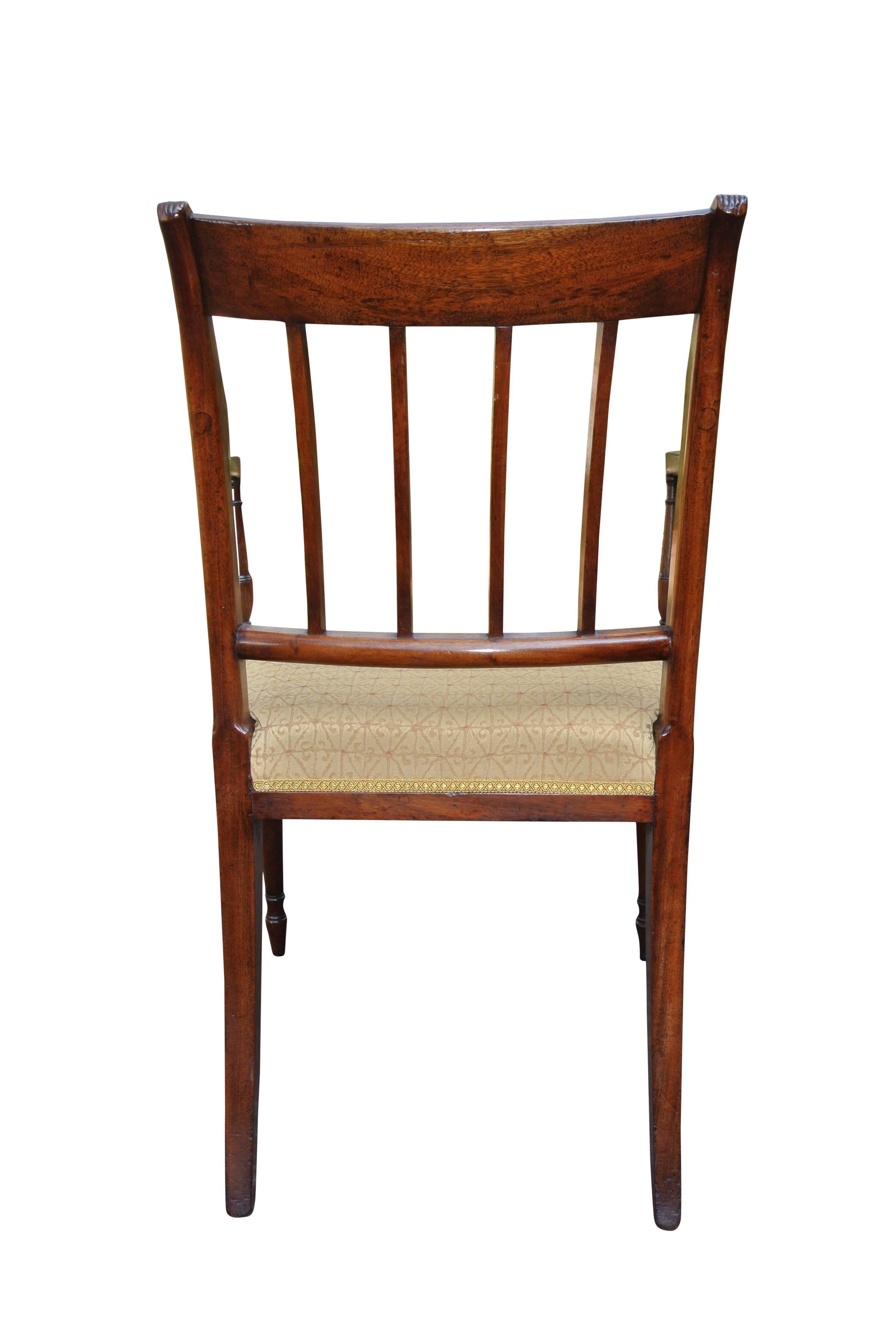 Set of 12 beautiful quality Sheraton design mahogany dining chairs, having been recently reupholstered. The two carvers and six side chairs are of the period, four identical side chairs were made in circa 1880 by J Murphy of 215 Brompton Rd